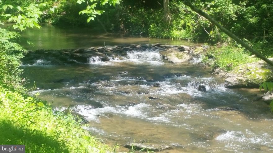 Oh My! What an amazing retreat from the daily "Rat Race!".  Almost entirely wooded, this 51+ acre hill-top woodland retreat comes with the "Little Falls" stream flowing through, offering a screen grassy meadow for spending lazy Summer days having picnics and playing in the flowing Little Falls Creek!  What a lucky find tucked away in upper Baltimore County!  Located just walking distance around the corner is a beautiful waterfall where Little Falls crosses under Gores Mill Rd.  At the top of the hill is the three bedroom, two bathroom ranch style home awaiting your creative design, already started, renovations!  A hunter's paradise as well, this secluded location may be just what you have been looking for!