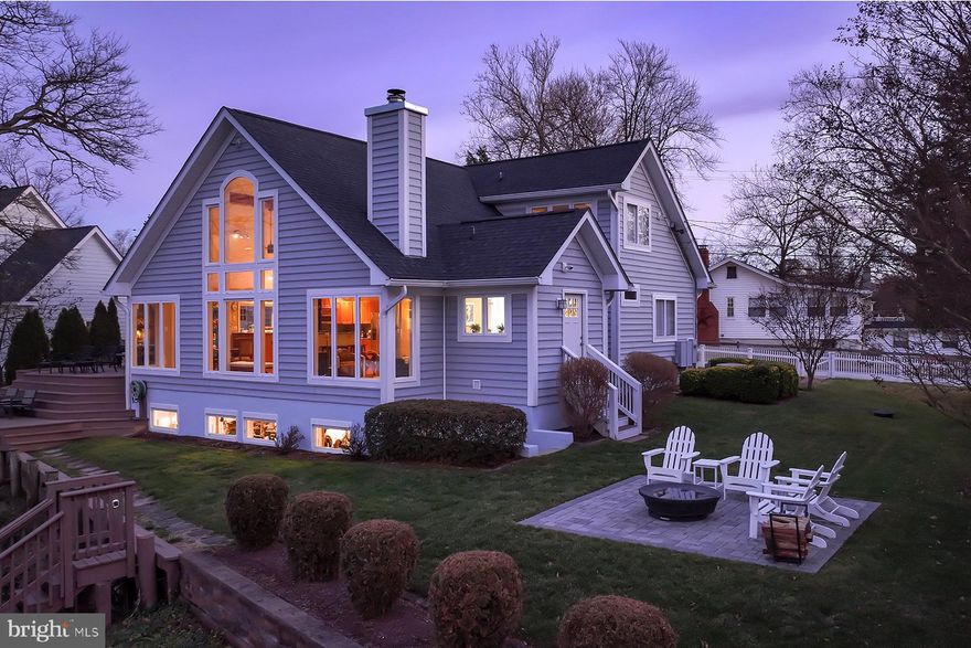 Captivating water views abound at 315 Cove Road, located on protected Granville Creek just off the South River. This meticulously maintained waterfront home offers an unbeatable combination of property size (located on a triple lot), turnkey condition, and incredible pier complex. Virtually every system and many structural components have been updated or replaced, including appliances, roof, HVAC systems, hardwood floors, and all interior doors. With unobstructed water views, a private multi-slip pier with a rare, covered slip and deep water, new shoreline management and rip rap, and just minutes to the Chesapeake Bay, this home is a boater’s dream. Step inside to a bright and open floor plan, where the dramatic two-story great room takes center stage, filling the space with natural light and water views. The updated kitchen has newer appliances and the hardwood floors throughout add warmth. Relax by the wood stove in the seating area on a cold evening. The two-level waterside deck just off the great room is ideal for having meals al fresco and entertaining. The main level bedroom has ample space, and the full bathroom has been beautifully updated. There is a wonderful bonus room on the main level, perfect for a media room or overflow guest room. There is also a new laundry room with pantry on this floor that has outside access. Upstairs, the spacious primary suite’s large windows bring in so much natural light and the view extends out to the South River. The suite includes two walk-in closets and a renovated bathroom. A second upstairs bedroom has its own new, ensuite bath and multiple closets. Overlooking the great room, the loft is perfect for a home office. The walk-out lower level, with its 9-ft ceilings and new windows, offers many possibilities such as an exercise area or maker’s workshop. This unique waterfront opportunity combines modern upgrades, public water & sewer, thoughtful design, and unparalleled access to the water. The community has a club house, boat ramp, playground, basketball & pickle ball courts, and baseball field. Conveniently located near Annapolis, DC, and Baltimore, this home is the perfect blend of privacy and accessibility.