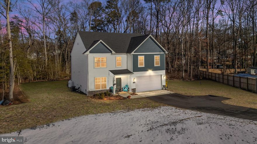 Experience the perfect blend of contemporary design and peaceful privacy in this nearly-new Modern Craftsman, completed just over a year ago. Situated on a sprawling .88-acre lot backed by a serene treeline, this home offers the rare combination of a "new build" feel without the wait, all set within a generous, established landscape.
The main level is designed for both effortless entertaining and comfortable daily living. The spacious, light-filled kitchen serves as the centerpiece, flowing seamlessly into a large family room. Whether you’re hosting holiday gatherings or enjoying a quiet evening, the open-concept layout and high-contrast finishes create an atmosphere of modern elegance.
Upstairs, the home features four generously sized bedrooms, offering flexibility for growing families, a home office, or guest accommodations. The primary suite is a sanctuary, boasting impressive proportions and an ensuite bathroom. Additionally, the third level offers a large unfinished area with a full staircase for storage or the possibility of added living space.
Don’t miss the opportunity to own a designer-level home on a premium lot that offers space to breathe and room to grow.