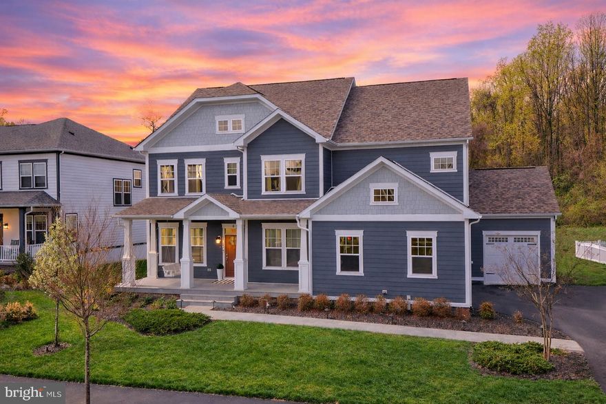 This beautifully upgraded, east-facing single-family home, built in 2021 on a premium lot by Beazer Homes, backs to serene woods and offers 5 bedrooms with the option for a 6th bedroom or office, 4.5 bathrooms, and a spacious 3-car garage with an extended driveway for additional parking.
Designed for comfort and elegance, the home features bright, open-concept living spaces filled with natural light, complemented by 10-foot ceilings, upgraded chandeliers, and a seamless flow between formal and casual areas. A butler’s pantry enhances functionality, while the gourmet kitchen impresses with ceiling-height cabinetry, glass-front accents, under-cabinet smart lighting, beverage refrigerator, premium appliances, and a full-height backsplash.
The living room showcases a striking floor-to-ceiling accent wall with an electric fireplace, while the sunroom with a brick feature wall offers a warm, inviting space with peaceful wooded views and direct access to outdoor living.
Upstairs, the luxurious primary suite features a private sitting area, expansive walk-in closets, and a spa-inspired bath with soaking tub, walk-in shower, and dual vanities. Additional bedrooms include a guest suite with private bath and two bedrooms connected by a Jack-and-Jill bathroom, along with a well-equipped laundry room.
The fully finished basement provides versatile living space with a recreation area, media room with projector, bedroom with full bath, gym, and rough-in for a future wet bar.
Outdoor living is exceptional, with over $150,000 in upgrades including a covered deck with built-in speakers, an expansive patio, and a fully equipped outdoor kitchen with a high-end Napoleon grill connected to natural gas, along with dining space, built-in seating, and areas for gardening and entertaining.
Additional features include wood flooring throughout the main and upper levels and select basement areas, a tankless water heater, dual-zone HVAC, water softener, RO system, an 8-zone sprinkler system, dedicated garage circuits, and multiple hose connections for convenience.

Located in the award-winning Willowsford community, residents enjoy scenic trails, resort-style amenities, and a unique farm-to-table lifestyle.