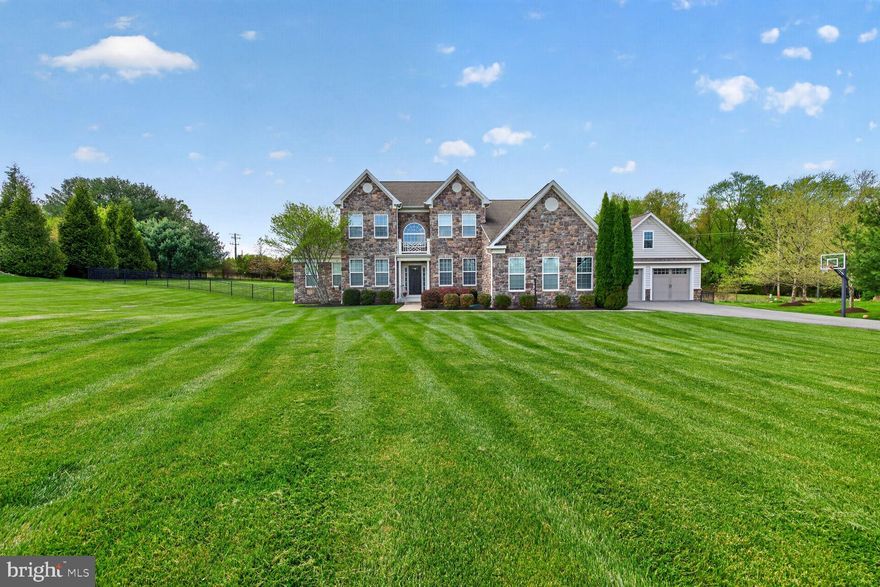 Welcome to 15320 Sweetbay St — a gorgeous stone-front colonial offering over 6,000 square feet of beautifully designed living space. This luxurious home showcases a wealth of architectural detail, including gleaming hardwood floors, decorative molding throughout, and an open-concept layout ideal for both everyday living and entertaining.

The light-filled sunroom is a true highlight, featuring a cathedral ceiling and stunning Palladian window that creates a warm and inviting atmosphere. At the heart of the home is the gourmet kitchen, complete with a dramatic quartz waterfall island, stainless steel appliances, dual wall ovens, and a gas cooktop — perfect for any home chef.

Step outside to enjoy the outdoor patio, ideal for relaxing or hosting gatherings. The fully finished basement provides additional versatile living space for recreation, fitness, guests, or a home office. For added comfort and peace of mind, the home also includes a whole-house generator.

A rare opportunity to own an elegant and spacious home in sought-after Woodbine!