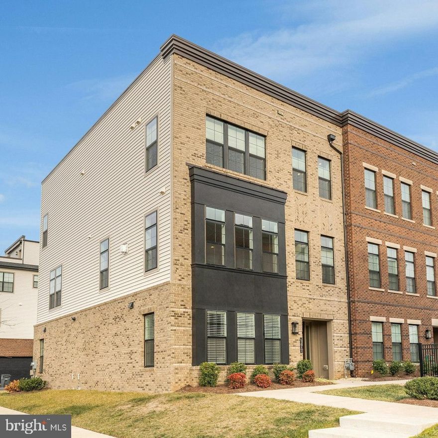 Welcome home to this incredible end unit townhome with elevator access to each level in the conveniently located Regency at Belmont 55 and older community. This stunning home was tastefully designed with over $150,000 in builder upgrades including 8" hardwood flooring throughout & has been meticulously maintained by the original owners. Featuring 4 bedrooms, 3.5 baths & over 3200 square feet of indoor living space plus an expansive upper level terrace. The inviting cover entry greets you as you enter into this home. The main level open concept design offers incredible natural light with tons of windows. Gourmet kitchen with oversized island, upgraded cabinetry, upgraded quartz countertops & pantry with custom shelving. Spacious dining room opening to the large living room with cozy fireplace. The large primary suite features walk-in closet w/ custom built-ins & spa inspired bathroom with upgraded gold fixtures/faucets & Carrera marble countertops. Two secondary bedrooms, a second full bath & laundry room complete this level. The fourth level features an incredible expanded upper level rooftop terrace with upgraded pavered flooring & gas line connection. The entry level fourth bedroom suite with private bath & walk-in closet. Two car rear entry garage with keypad. Additional upgrades include upgraded lighting & electrical wiring throughout, upgraded plumbing fixtures, oak staircases with iron balusters & more. This active community offers many gatherings & clubs & also allows you access to Belmont Country Club amenities through your social membership with includes pool, tennis, pickleball, trails & more. Additional fitness & golf membership upgrades are available as well. The Regency at Belmont is conveniently located near commuter routes, shopping, dining, entertainment, INOVA hospital & more.