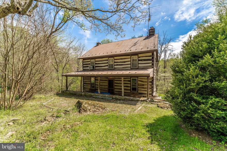 Appointment required to enter the property. Awaiting your personal touches - original charming re-chinked log cabin offers privacy while listening to the sound of the stream as you relax on the back screened-in porch.  This cabin boasts 8'+ ceilings and a brick fireplace.  Natural stone floor covered front porch and stone retaining wall. Just installed waterproofing system for the basement with a full transferable warranty to the purchaser which will allow the basement to have the potential for future living expansion. Full walk up attic space. Live here year-round or have your own private retreat for weekends away to enjoy relaxing or recreating. Have the best of both worlds – the pleasure of the great outdoors with the conveniences of in-door modern living . Structural solid German style bank barn with solid wood upper floors and large stall and stabling potential underneath. This could be ideal for sheep, goats, a few horses or other livestock. For access there are two entrance gates off of Spruce Run Road. The second gate opens to the full driveway past the barn to the house. Use caution as road is a little bumpy. For future subdivision or regular access both gates are totally useable. Verify with Frederick County the three plus one subdivision rights. Appointment required to enter the property. Verizon landline is available.