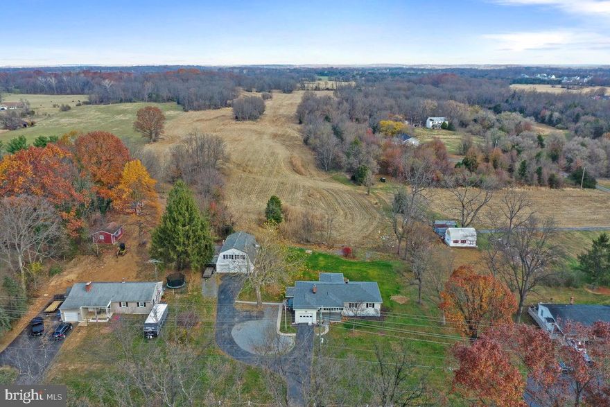Welcome to this ranch-style home situated on a .75 acre lot that backs up to a cornfield located less than 3 miles to downtown Shepherdstown. This home has been fully remodeled and is a car enthusiast's dream.  Imagine owning a detached 5 car garage! The upper level of the detached garage features a large open space: it’s ideal for a hobbyist, craftsman, or as a flexible project space. There is a dumbwaiter/lift with pulley system for bringing heavier items or supplies up to second level from first. Both the house and detached garage feature new gutters and a new roof with 30 year architectural shingles. Stepping inside, you will appreciate the new vinyl plank flooring throughout. The living room features bow windows permitting plenty of natural light and gorgeous built-in shelving.  The kitchen has been fully remodeled including new quartz counters, new white cabinets, new kitchen island, and new Stainless Steel Appliances. There are also new light fixtures throughout. Both bathrooms have been fully remodeled featuring new ceramic tile flooring, new vanities and lighting, new commodes, new glass enclosed shower with ceramic tile backsplash and niche, and new bathtub with ceramic tile backsplash.  Downstairs, the 40' by 15' recreation room with new vinyl plank flooring offers a wood stove and wood burning fireplace to cozy up during those cold months. Located off the rec room is the laundry room and utility room. A new central a/c system has been installed. You will absolutely fall in love the screened-in rear porch new tile flooring to take in the scenic views of the farm in rear of property. Don't wait: schedule your tour today!