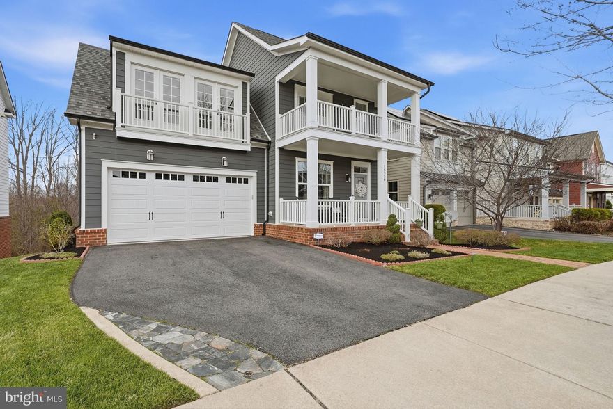 Overlooking the 12th fairway of the Jack Nicklaus Signature Golf Course in Potomac Shores, this beautifully maintained 5-bedroom, 3 full and 2 half bath home offers STUNNING VIEWS, thoughtfully designed living spaces, and exceptional indoor-outdoor living in one of the community’s most sought-after locations. From the moment you arrive, the home stands out with its welcoming front porch, upper covered balcony, and distinctive double Juliet balconies, creating STRIKING CURB APPEAL and setting the stage for the beautiful spaces inside. Step through the front door and you’re greeted by 9-foot ceilings, wide-plank engineered flooring, and an elegant staircase that anchors the main level. A private home office with glass French doors sits just off the foyer, ideal for working from home or quiet study. The open kitchen and family room form the heart of the home and are designed for both everyday living and entertaining. Rich espresso cabinetry, granite countertops, a custom tile backsplash, under-cabinet lighting, and a gray-toned island create a warm and sophisticated space. The dining area is surrounded by windows that fill the space with NATURAL LIGHT and lead directly to the COMPOSITE DECK overlooking the golf course, perfect for outdoor dining and relaxing evenings. The family room features custom built-ins and CEILING SPEAKERS, creating a comfortable gathering space for family and friends. Just inside the two-car garage, a mudroom with built-in bench and powder room adds everyday convenience. Upstairs, the spacious primary suite captures peaceful golf course views and features two walk-in closets and a spa-like bath with soaking tub, dual vanities, and a large walk-in shower. Three additional bedrooms complete this level, including 1 with its own full bath and access to the covered front balcony, along with a hall bath and a laundry room with utility sink. The WALK-OUT lower level offers incredible flexibility for entertaining and everyday living. Enjoy a dedicated theater room with power recliners, television, speakers, and equipment THAT CONVEY, creating the ultimate movie-night experience. The large recreation room offers abundant space and includes a PLUMBING ROUGH-IN for a future wet bar. With high ceilings, large windows, and direct access to the patio, the space feels bright and open. This level also includes a 5th legal bedroom and a half bath that can easily be converted to a full bath. Outdoor living is just as impressive as the interior. The composite deck with built-in planters and string lighting overlooks the fairway, while the CUSTOM PAVER PATIO with knee wall and BUILT-IN FIRE PIT creates the perfect spot for relaxing evenings and gatherings. The FENCED BACKYARD with a 4-zone in-ground sprinkler system keeps the landscape looking its best. RECENT UPDATES INCLUDE: new carpet (2026), water heater (2026), Garage Door (2025),  Samsung Bespoke Refrig. (2025), dishwasher (2024), washer and dryer (2024), garbage disposal (2025). Residents enjoy resort-style living in Potomac Shores, where the $180/month HOA includes high-speed 1G internet, trash service, and access to exceptional amenities including three pools, a state-of-the-art fitness center, the Jack Nicklaus Signature Golf Course and Tidewater Grill, miles of scenic walking trails, social clubs, and year-round community events. Covington-Harper Elementary, Potomac Shores Middle School, the Ali Krieger Sports Complex, and John Paul the Great Catholic High School are all located within the community. The future VRE station and town center are already planned, adding even more convenience to this vibrant neighborhood. Ideally located near Marine Corps Base Quantico, I-95, Route 1, Stonebridge Town Center, and Potomac Mills, this home offers the perfect blend of lifestyle, location, and comfort. GREAT OPPORTUNITY TO ASSUME 2.75% FIXED RATE 30 YR MTG. SELLER DOES NEED SUBSTITUTION OF ENTITLEMENT.