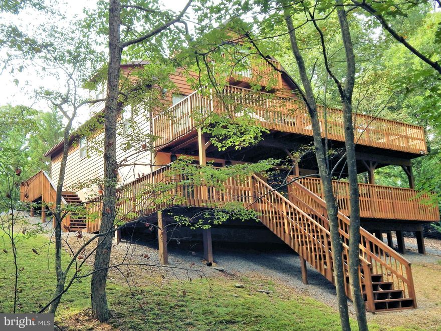 Stunning chalet of the highest quality, If you are searching for the best your search stops here! Beautiful mountain views that change with the seasons. Three floors of living, game room, hot tub, central air / heat & wood stove. Located in River Ridge, premier waterfront community allows you to take advantage of miles of river, both the Cacapon and Potomac, hiking & biking trails, Sidling Mt WMA!