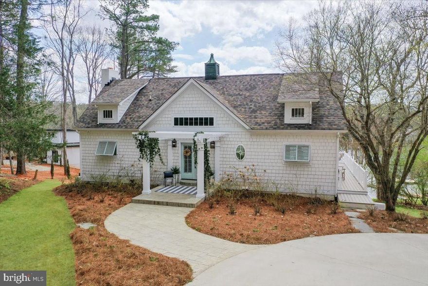 Motivated Seller. Luxury lakefront living at its finest! A Stunning Custom Structures renovation, Southern Charm, conveniently located 1 mile from Bridgewater Plaza offers modern elegance & breathtaking water views. A governor's drive leads to the arbor entry & grand double doors. Inside, the vaulted great room is full of natural light, featuring a modern driftwood gas fireplace. The chef's kitchen boasts a large island, gas range & custom copper hood. The main-level primary suite impresses w/ custom tile, dual sinks & a walk-in shower, plus a private patio to soak in lake views. Another full bed & hall bath completes the main level. Upstairs, a spacious bedroom w/ an en-suite awaits. The terrace level is built for entertaining w/ a den, game room, bar, bunk room, bedroom & dual laundry. Outside, enjoy a hot tub, gas firepit & private dock w/ a bar shed. Staged by Ferguson Partners. No HOA or restrictions, ideal for personal use or for VRBO (sleeps 18). On Public Water & Public Septic.