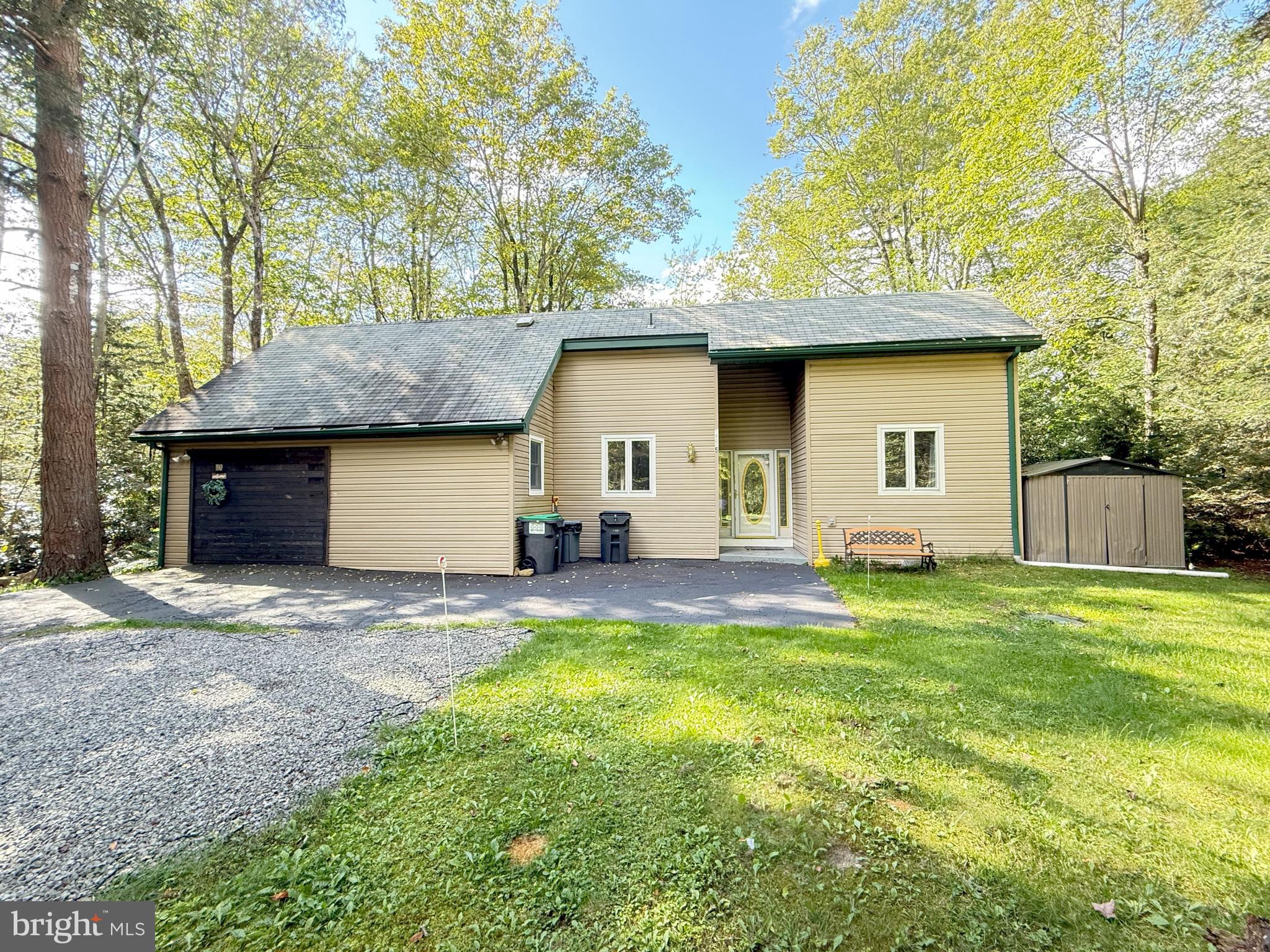 Nestled on a wooded lot backing up to the golf course, this 3-bedroom, 2.5-bath contemporary home offers the perfect blend of style, comfort, and natural beauty. The open floor plan features a stunning sunken living room with high ceilings, exposed wood beams, and a cozy wood-burning stove, creating a warm and inviting atmosphere. The loft bedroom with a private bath adds flexibility for guests or a private retreat. Sliders open to a spacious deck with hot tub, ideal for entertaining or simply relaxing while enjoying the serene views. Located in the desirable Pocono Farms Country Club, residents enjoy access to an array of amenities including golf, a lake, swimming pool, fitness center, and more. This home is a true retreat, combining modern design with the best of Poconos living!