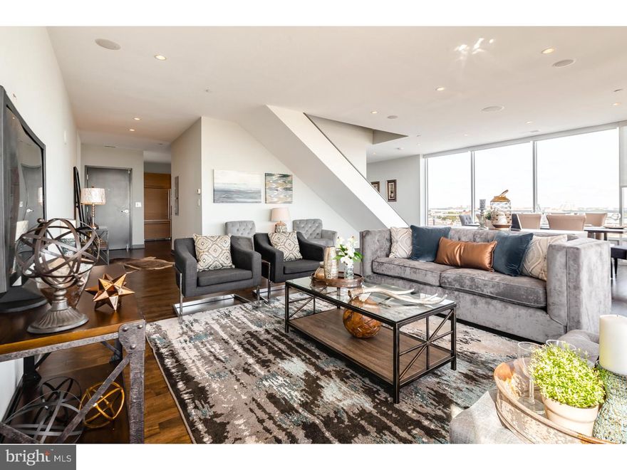 Behold this rare opportunity to own the developers unit "jewel box" villa in the highly coveted Lofts at Bella Vista condominium. This breathtaking 3 bedroom, 3.5 bath, 2423sf corner condo boasts southern and eastern exposures, with ever-extending unobstructed views, from sunrise to sunset, from the Ben Franklin to the Walt Whitman. Perched above the city of Philadelphia, this Villa level condo features the finest in privacy and exclusivity. Enjoy the ultra-unique privilege and freedom of owning three levels of outdoor space, totaling approx. 1100sf, including a wraparound terrace, allowing for the maximum in relaxation and entertaining. The interior space has been set up for the highest functionality, and complete with the finest fixtures and details. The custom Schiffini kitchen is truly fit for any range of chef, complete with JennAir Stainless Steel appliances, granite, rich marble, island bar, walk-in pantry and mystic brown hardwood flooring. Relax in the wide open living room with its dramatic floor to ceiling windows allowing immense natural light to flood the entire space. The Rifri bathrooms have been imported from Italy, with Incia stone tile baths and oversized stall showers. The bedrooms are all suites, complete with all the space, light and storage space you could desire. More amenities include surround sound & Sonos speakers throughout (and on main terrace), newly refinished floors and brand new carpets, custom closets, remote control shades + black out shades in bedrooms. Not only in this condo unit to die for, but the building itself stands out with its trendy lobby, newly redone common area, and most importantly, its high percentage of owner occupants, proving a strong pride of ownership. Lastly, this home includes 1-car deeded parking. Incredible location, walkable to a diverse array of restaurants, to the fresh produce of the historic Italian Market, to all the amazing festivities and amenities of Avenue of the Arts & Center City, to public transportation? everything! This gem in the sky is one not to be missed.