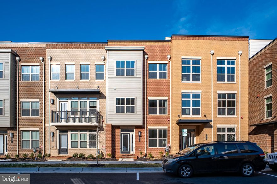 Lavish 4-Level Townhome in the Heart of Fairfax City! Ideally located just steps from shopping, dining, and future on-site retail, this spacious and beautifully upgraded home boasts over $75K in upgrades. The residence offers 4 bedrooms, 4.5 baths, a covered balcony, rooftop terrace, and an oversized 2-car garage. The entry level features LVP flooring and a private bedroom with a full bath, perfect for guests or a home office. Upstairs, the open-concept main level is designed for both everyday living and entertaining, showcasing a stunning center kitchen with quartz countertops, a massive island, classic white cabinetry, stylish white backsplash, apron-front sink, stainless steel appliances, and access to the covered balcony. The third level includes a luxurious owner’s suite with a walk-in closet, dual vanities, frameless shower, and tiled bench, along with a secondary en-suite bedroom and a conveniently located laundry room. The top level offers a spacious loft ideal for entertaining or movie nights, an additional bedroom with a walk-in closet and full bath, and access to the rooftop terrace, where you can enjoy beautiful sunrises and sunsets. Fantastic location with easy access to Route 66, Route 50, Route 29, and Route 123, and just minutes from Wegmans, Costco, Whole Foods, Fair Oaks Mall, and many popular restaurants and shops.