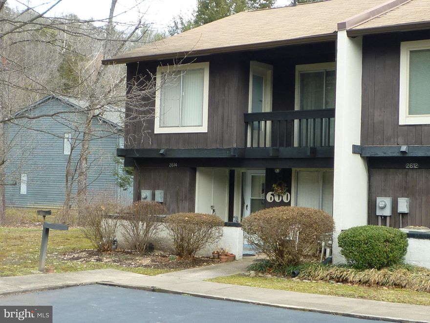 Great Location -  end Unit Townhome featuring Great Room with wood burning Fireplace, Nicely appointed Kitchen, all Appliances including Washer & Dryer. Two Bedrooms and 1.5 Baths. Walk out from the loft area to an elevated rear deck or enjoy  the ground level patio perfect for cook-outs. Listen to the creek as it flows by the rear of the property. Watch the Golfers, read a book, or just relax and unwind. No exterior maintenance...