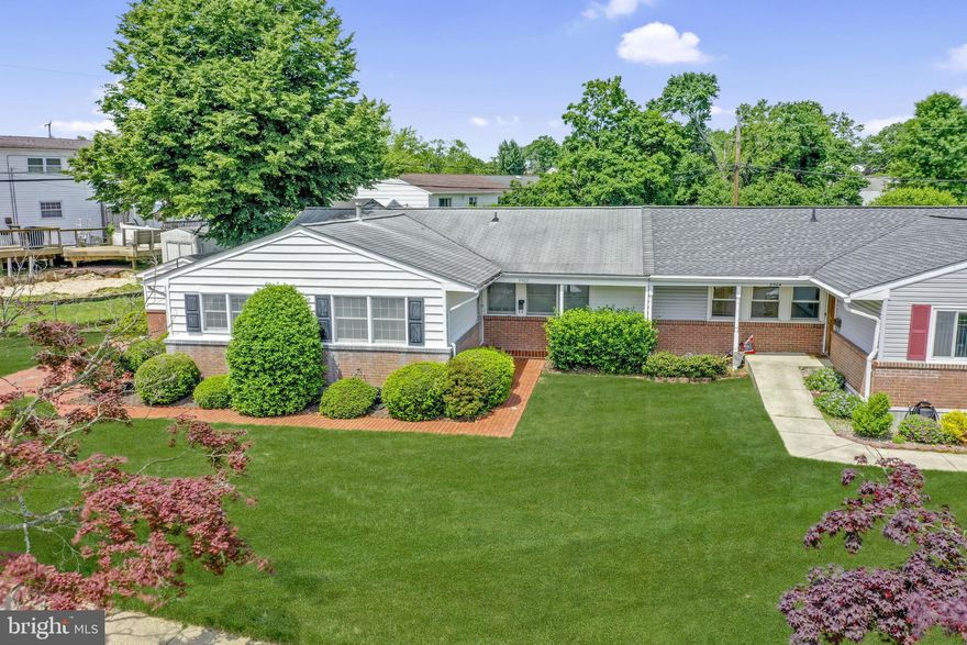 New Price - Motivated Seller! Quaint rancher-style semi-detached home in Hallmark Manor - Parkville.  Look for the unique red-tile driveway and sidewalk! Updated Kitchen with tile floor, tile countertops and stainless steel appliances. Light-filled Living/dining room combination with built-in cherry cabinet and bar back with sink.  Updated hall bath with tiled floor, walls and ceiling! Primary bedroom with bulk-head recessed lighting and full private bath. Third bedroom is suited for an office with built-in desk and shelving. Rear wooden deck with built-in benches overlooks privet hedge lined rear yard.   Full, unimproved basement with full bath rough-in and toilet plus plenty of storage space and outside entrance to rear yard.  See MLS documents for detailed brochure.