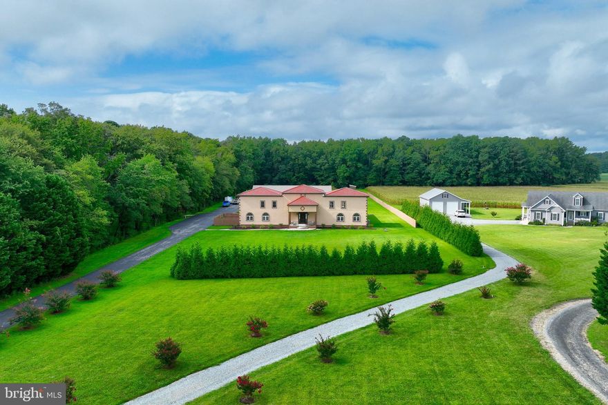Welcome to your private paradise in Bishopville, MD a truly unique 20-acre estate combining luxury living, recreation, and versatile workspace in one extraordinary property. Just minutes from Ocean City and Delaware beaches and many coastal attractions, this property offers coastal convenience with peaceful rural privacy.

This custom-built 3,840 sq ft home showcases thoughtful design, quality craftsmanship, and attention to detail throughout.. The home features an inviting layout with 9’ ceilings on the first floor and 8’ ceilings on the second floor, creating a bright and open feel throughout.

Enter into a striking foyer graced with an oversized chandelier that sets the tone for the quality found throughout. The heart of the home is the well-appointed kitchen, featuring Silestone quartz countertops, premium Wolf cabinetry, and a large island with built-in microwave and drink refrigerator. Stainless appliances include a gas cooking range, double over/under ovens, refrigerator, washer, and dryer. Tile flooring anchors the kitchen, while luxury vinyl plank and carpet extend through the remaining living spaces. Elegant chair rail and wainscoting highlight the dining room and kitchen, adding classic character.

The residence offers comfortable living and entertainment spaces, including a dedicated game room complete with foosball and two ping pong tables — perfect for family gatherings or lively entertaining. The primary suite boasts a custom closet organizer for maximum storage and ease of living. Efficient mini-split heating and cooling systems provide year-round comfort.

Construction and functional upgrades abound, including blown-in attic and batt insulation, 200-amp electrical service metered separately, ample 110V outlets throughout, dedicated 220V air compressor capability, and LED lighting in the workshop space.

A standout feature is the expansive warehouse/flex building, ideal for multiple uses. This space includes separate entrances and utilities, with a large roll-up door (16’ x 14’), two separate 36” entry doors, and a metallic epoxy floor system. Of the total area, 1,536 sq ft is finished, heated, and cooled, providing flexible studio, office, gym, music room, or hobby space — while an additional 2,304 sq ft of unfinished area offers endless storage or workshop potential.

Step outside to your own resort-style oasis. The saltwater shotcrete/plaster pool is gas-heated and surrounded by a durable urethane flake system pool deck. The outdoor kitchen with stainless grill, side burner, hot/cold water sink, and concrete countertops makes entertaining effortless. Reclaimed Pennsylvania barn wood accents at the outdoor kitchen and pool deck inject rustic charm and character. An open-air fire pit adjacent to the pool deck invites evening relaxation under the stars.

The property’s landscaping enhances both privacy and functionality, with stained wood privacy fencing, rod iron and CMU block around the pool area, and paver walkways at the front, rear, and driveway. Additional upgrades include a professionally graded drainage system directing runoff to an on-property drainage ditch completed prior to home construction.

Exterior finishes are low-maintenance and stylish, including stucco/EIFS siding, Andersen vinyl windows, a standing seam metal roof at single-story sections, and composite barrel tile roofing on the two-story portions. The insulated garage provides practical storage and workspace potential.

This Bishopville estate delivers unparalleled versatility in a serene rural setting, all while being just a short drive from Ocean City and Delaware beaches.

Don’t miss this rare opportunity to own a truly remarkable lifestyle property on Maryland’s Eastern Shore!