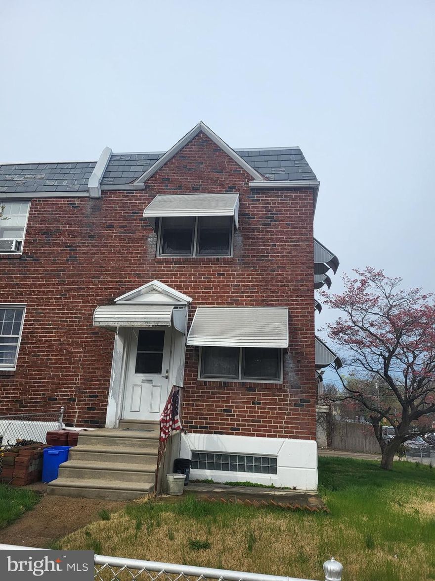 Spacious end rowhome with large yard awaiting your personal touches. Hardwood flooring throughout, three nicely sized bedrooms, one full bathroom and walkout basement with attached garage for additional parking or storage. Close to public transportation.