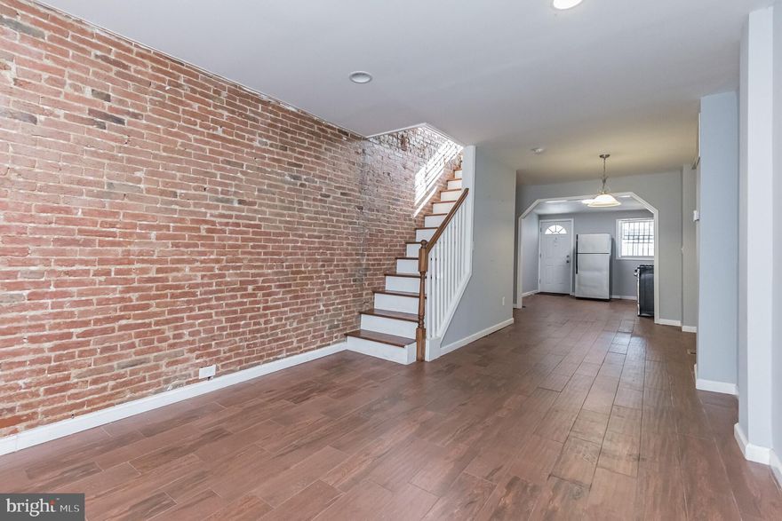 Welcome home to this beautiful 1 bed, 1 bath Colonial townhome in Washington Village! Walk into a light and bright open space layout with hardwood floors that flow throughout the home. The living room features recessed lighting and an exposed brick accent wall that extends into the dining room and upwards to the upper level. Entertain guests easily in the dining room that features centerpiece pendant lighting. The eat in kitchen feature plenty of counter and cabinet space, a deep sink with side detachable faucet, and all stainless steel appliances, including a gas stovetop oven combo with industrial hood. Half bath completes the level. Relax in the bedroom upstairs that features a cooling ceiling fan, recessed lighting, and plenty of closet space. Full size bath features tub/shower combo with subway tiles and recessed lighting. Take a break on your raised deck in your fully fenced in backyard. Easy access from the second door leading into the kitchen for convenient grocery drop off. Great location! Near the MTA bus line, walking distance to UMD, and nearby Pigtown. Also close to multiple shopping and dining destinations. Do not miss out on this one!