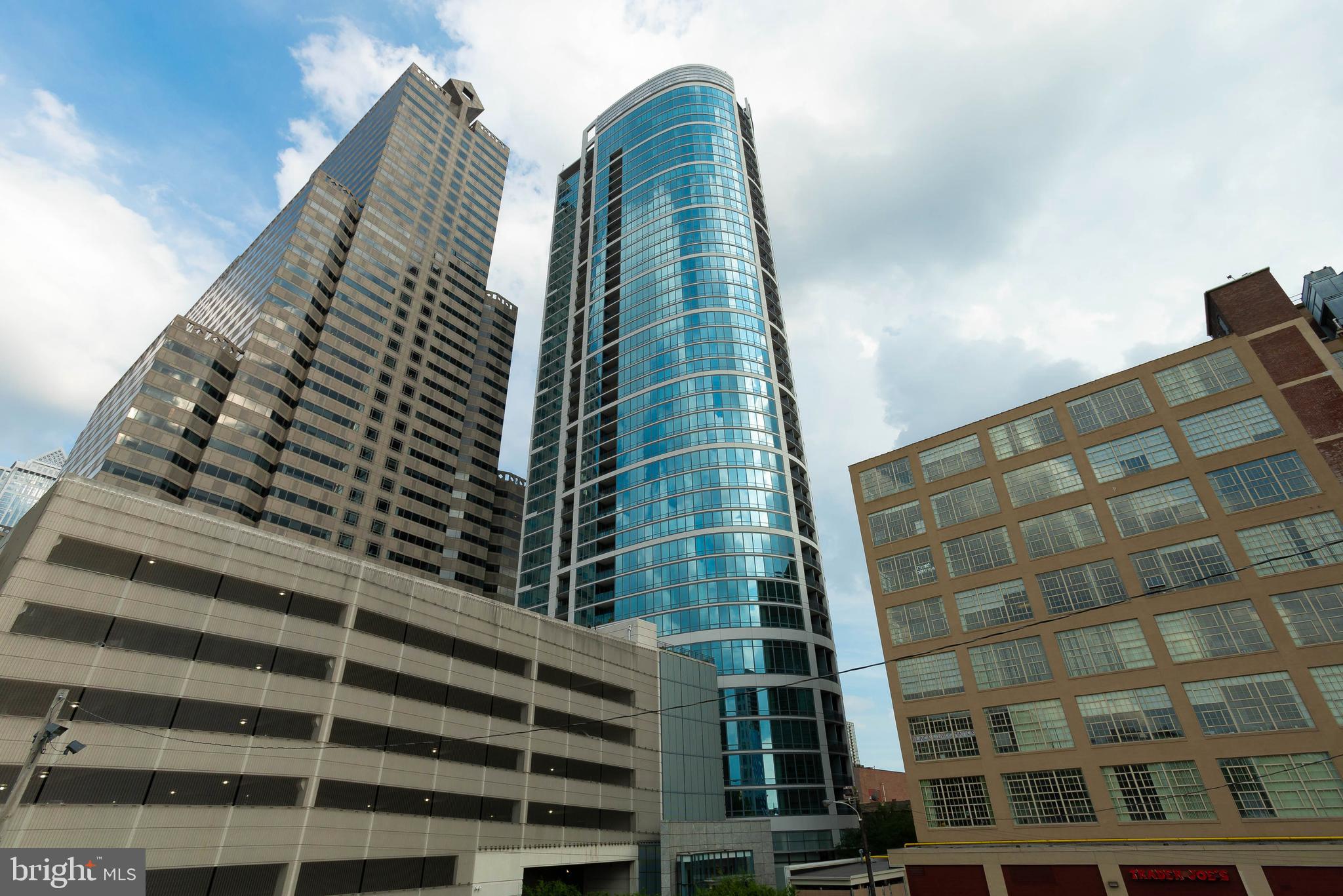 Experience the ultimate convenience and luxury of downtown living in this southern facing apartment at The Murano overlooking Market Street in downtown Philadelphia, Pennsylvania. Easily accessible on the 2nd floor, Unit 204 contains just under 1000 SF of modern interiors and impresses immediately upon entry, with wall to wall windows, an open concept living space, hardwood floors and a gourmet kitchen. A huge bedroom and walk in closet connect to the full bathroom. Washer/dryer included. This designer condo building is located at the prominent intersection of 21st and Market Streets, just a short stroll from Amtrak's 30th Street Station and Septa regional rail, GIANT, The Fitler Club, Rittenhouse Square, The Four Seasons and the Schuylkill River Trail. The Property is situated in the middle of the Central Business District, the beating heart of Philly, with a Trader Joe's on the ground floor of Market Street at 21st. Enter through the private lobby, staffed 24 hours with security and doorman. Full service amenities in The Building include a fitness center, party lounge, package room, sunset terrace, heated lap pool, and more. Parking space and storage included with sale. Easy access through the car port and into the remote controlled garage. The Philadelphia urban lifestyle is at its finest, at The Murano Condominium Unit 204.