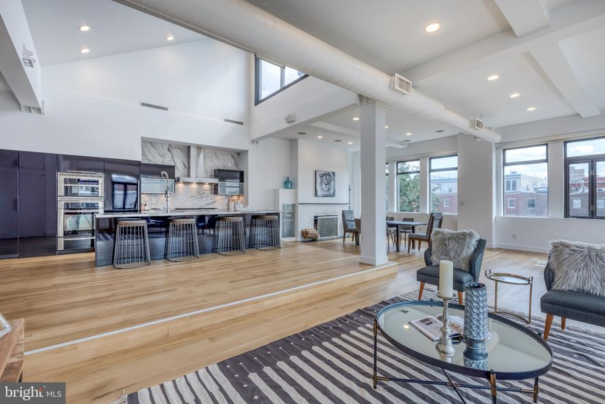 Your mother said it's impolite to stare...but some rules are made to be broken. Stunning, spacious, and sun soaked contemporary corner penthouse on one of Old City's prettiest tree lined cobblestone streets. Private keyed elevator access opens directly into fantastic and bright open living space with tremendous ceilings, walls of windows, fabulous views, exposed beams, gorgeous white oak matte hardwood floors, and a fireplace for chilly nights. Rare and incredible layout for living/dining/entertaining. Featured in PhillyMag's Amazing Spaces, the open kitchen with huge island features SubZero refrigerator and freezer drawers, Icon 6 burner/grill cooktop and speed oven, Miele range hood, Bosch dishwasher, custom cabinets and pantry from Society Hill Kitchens, Veyko Design custom stainless counters, and Nemo backsplash. Luxurious corner master suite with huge custom Lema walk in closet and incredible private bathroom with views of the Ben Franklin Bridge, soaking tub, frameless glass rain shower, and floating Modulnova vanity with custom top, Newform faucets, and defogging mirrors. Sunny 2nd bedroom with door to shared terrace, and 3rd br/office with wall of closets round things out with plenty of custom storage throughout. Contemporary design meets the original factory loft detail throughout, and the modern design is softened by thoughtful use of natural materials in the stone and flooring. This incredible space comes with 1100 sf of roof rights above the unit, as well as architectural plans by Agoos for a staircase and roof deck above with river, bridge, and skyline views. 1 car covered parking steps from the elevator, laundry in unit, and full of thoughful touches in a very livable layout. Live very well on one of the prettiest cobblestone streets north of Market, steps from restaurants, boutiques, coffee shops, gyms, & galleries. Quick access to transit and highways.