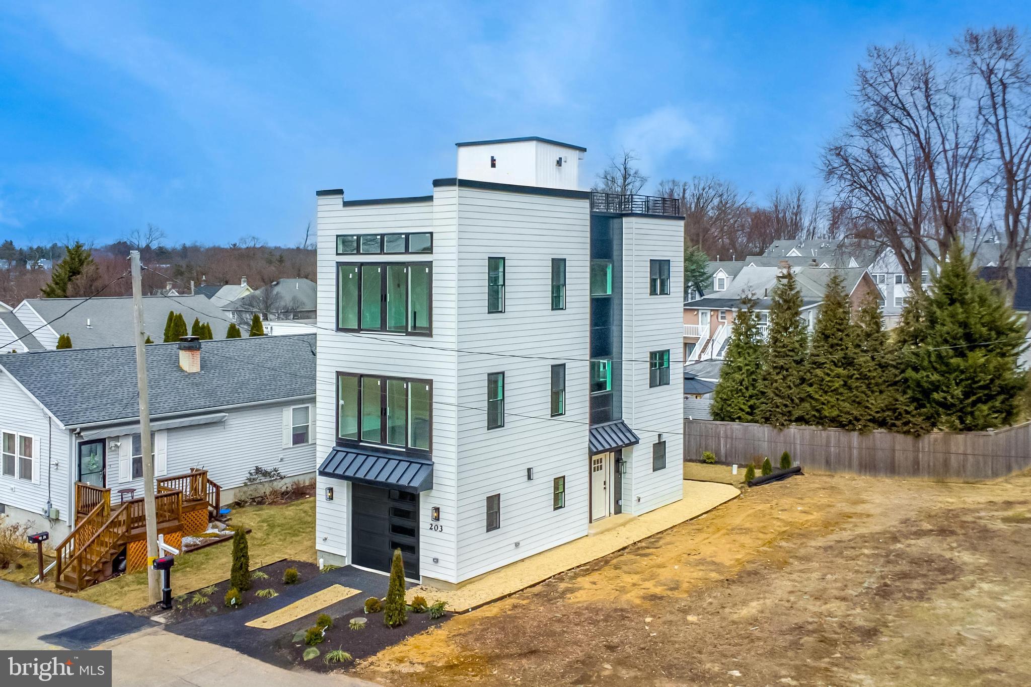 Welcome to 203 Church Street, a stylish new home located across from Odorisio Park, just minutes from downtown Wayne. This 4-bedroom, 3-full-bath detached home features an attached garage, ample parking, and a stunning rooftop deck with breathtaking views.
Step inside to discover modern elegance and luxurious upgrades throughout. Hardwood floors lead to a glass-enclosed stairwell, allowing abundant natural light to pour in through expansive windows and glass sliders.
The entry level offers a one-car garage with built-in storage, a wet bar, and a bedroom which walks out to the back patio perfectly suited for a quiet office or guest space. The second level dazzles with a gourmet kitchen featuring a 90" quartz island with a double waterfall design, 42" custom cabinets, and top of the line matte black appliances with gold hardware. Cooking enthusiasts will appreciate the gas range, stylish stone backsplash, range hood, and pot filler.
The third level includes a secondary bedroom, a beautiful hall bathroom, and a laundry closet for added convenience. The primary bedroom boasts glass sliders overlooking the park and a luxurious spa-like en-suite bathroom with tile from floor to ceiling, dual shower heads, a double sink vanity, and upgraded lighting throughout.
Descend to the lower level, a spectacular entertainment space featuring your own theater room. Equipped with a top-of-the-line projector, built-ins, wet bar, and a custom display.
One of the only homes near Downtown Wayne with a rooftop deck, this exceptional outdoor space is prepped with electrical connections, offering a stunning setting with park views, perfect for enjoying the outdoors under the open sky.
Located just five minutes from town in the prestigious Radnor School District—ranked #1 in Pennsylvania, your dream home awaits! Schedule a private showing or contact listing agent for more information.
