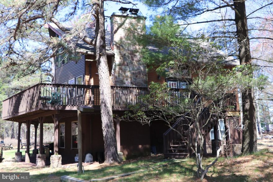 Your 4 Season Playground Awaits! Experience the perfect blend of serenity and adventure in this Lake Harmony retreat. Nestled on a mature  wooded lot, this home offers an outdoor sanctuary, TWO fireplaces & fabulous deck space ideal for après-ski gatherings or quiet morning coffees surrounded by nature. Located in a vibrant & friendly community, you'll have instant access to private lake, beach & tennis courts while being only minutes from Jack Frost & Big Boulder ski areas, local restaurants & entertainment. Whether you're looking for a full-time residence, the ultimate vacation getaway or an STR conversion, this home delivers the active lifestyle you've been looking for! Make your own dreams come true and let your creativity soar with three levels of spacious living, 5 bedrooms, 3 baths, outdoor fire pit and so much more. It is ready to be yours and I've got the key!