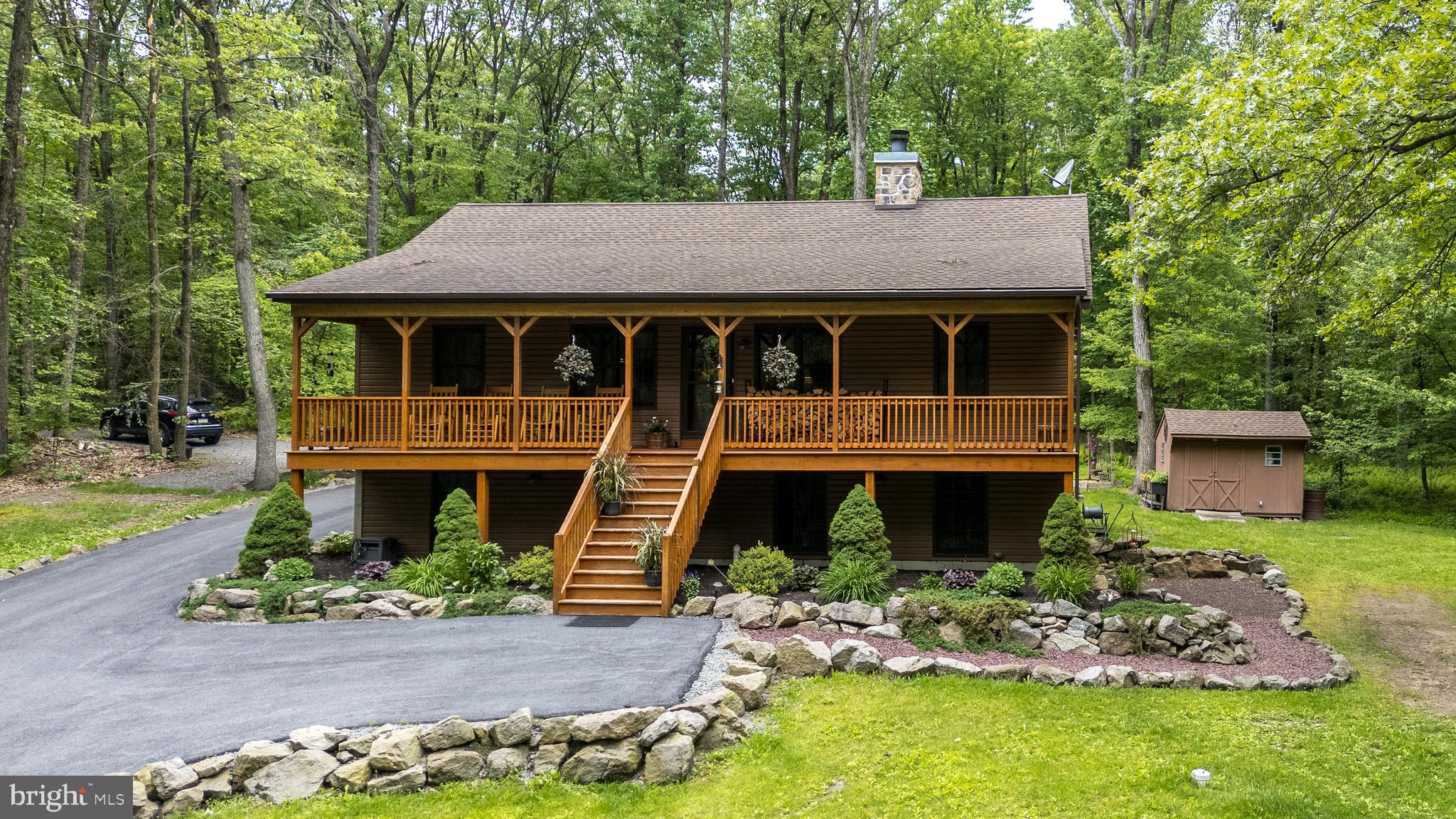Welcome to this custom-built 3 bedroom, 3 full bath home located on a beautiful 3.99 acre wooded lot
in Twin Valley School District! This country feel home has an open-concept main level with vaulted
knotty pine ceilings, a floor to ceiling stone wood-burning fireplace, recessed lighting, skylights and
hickory hardwood flooring. The kitchen has hickory cabinets, granite countertops and GE black
stainless steel appliances. The main level primary bedroom has a nice walk-in closet and an upgraded
full bath. There are 2 additional bedrooms and an updated bathroom to complete the main level. On
the lower level you will find a huge finished space with 9 ft. ceilings, lots of windows and recessed
lighting that would make the perfect family or recreation room with the option to add another
bedroom or in-law suite. Also here on this level, a third full bath and laundry. This level has its own
entrance that takes you outside where you will find an amazing, oversized detached garage with
electricity, including a 110 and 220 line, storage, work space and a separate large concrete pad
covered by a roof which could be a porch or additional storage space for firewood and outside
equipment. With almost 4 exceptional acres, this home is surrounded by trees, owner made trails,
outdoor fire pit, shooting range and a shed. Other important features of this wonderful home include:
a lovely front porch extending the full width of the home with breathtaking views, a back deck which is
great for outdoor entertaining and watching all the wildlife, a full house generator, a water treatment
system, a horseshoe shaped paved driveway, natural stone and boulder landscaping, and private road
access. Conveniently located near Shady Maple Market and Restaurant, Wawa, a Shopping Center off
of Rt 23 and minutes from the PA Turnpike. Be sure to schedule a showing today. You will not be
disappointed!