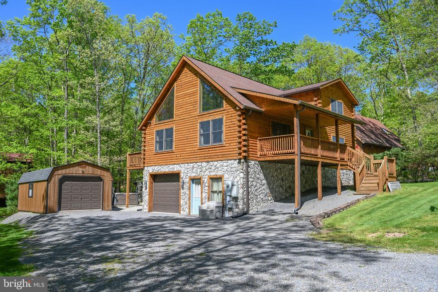 Tucked away in the heart of the breathtaking Sky Valley community—where every day feels like a retreat in your own state park—this stunning 3-bedroom, 2-bath log home offers the perfect blend of rustic charm and modern comfort. You’ll also enjoy unmatched access to nature and water recreation right outside your door.

Step inside to soaring cathedral ceilings and a spectacular great room anchored by a beautiful gas fireplace—perfect for cozy evenings with family and friends. The open kitchen/dining/living area has everything you need for all your family and friends. The loft above the living area adds character and flexibility, ideal as a den, office, or additional lounge space. The spacious primary bedroom and private bath is privately located upstairs, creating a peaceful retreat, while two additional bedrooms and a full bath on the main level provide comfort and convenience for family or guests.

Downstairs, a rec room offers the perfect hangout zone, game room, or hobby area, with direct access to the attached garage—great for gear, lake toys, or year-round storage. A bonus garage/storage shed keeps everything organized and out of sight.

Step outside to enjoy a beautifully level yard, ideal for lawn games, entertaining, or simply soaking in the natural beauty of Sky Valley. At night, unwind in the hot tub under a canopy of stars—your own private haven of peace and quiet.

Best of all Sky Valley offers 3000' of common lakefront that rivals the Deep Creek Lake State Park! 3 swimming platforms, multiple picnic pavilions, canoe racks, boat slips, jet ski area, trash building for the neighborhood, a pond for fishing, and for Sky Valley members, the only private boat launch on Deep Creek Lake. There is a waiting list for the dock slip. When homes sell the slip goes back to the association. Until you get your assigned slip you can launch your boat at the neighborhood boat launch. Explore the neighborhood on your golf cart or ATV! For the golfers in the group, it is only minutes to Thousand Acre Lakeside Golf Course. Find out more about this secluded lake access community in the mountains of Western Maryland on the Sky Valley Web Site.

Whether you’re swimming, boating, fishing, hiking, or just unwinding, this home is the ultimate year-round escape. With its mix of rustic elegance, thoughtful layout, and unbeatable setting, this log home is truly one-of-a-kind.
