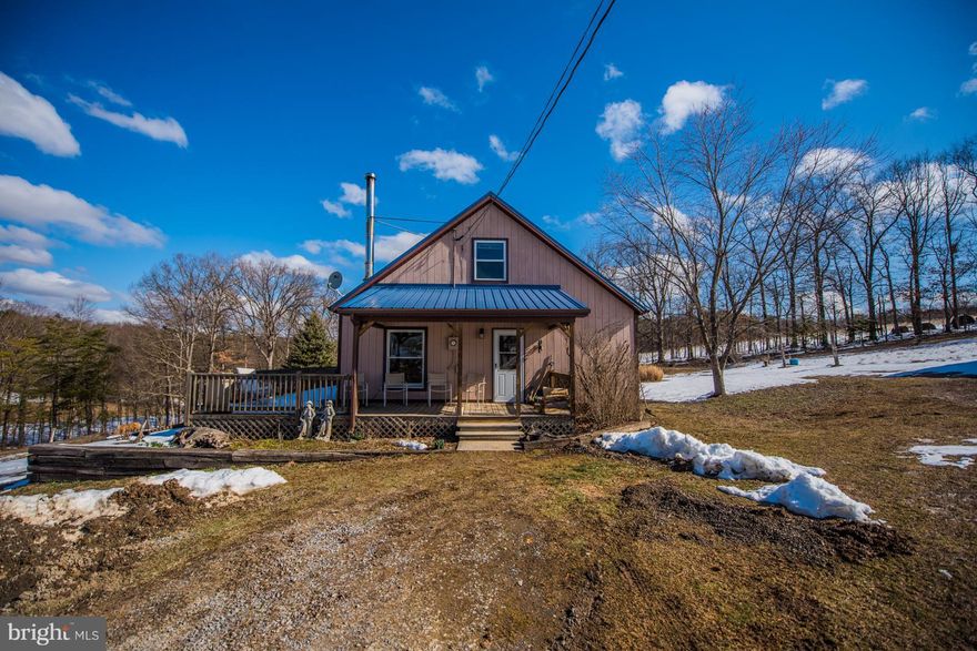 This A Frame style home has lots of space and cute as can be. Sits on 3.21 unrestricted acres with 3 stall barn, Machine shed and storage shed.  Fenced pasture area for horses. wet weather stream and outlining trees. Barn has electric and water, Machine shed has electric and wood stove. Located at the end of the lane where you can sit on the front porch, deck or balcony and just relax.