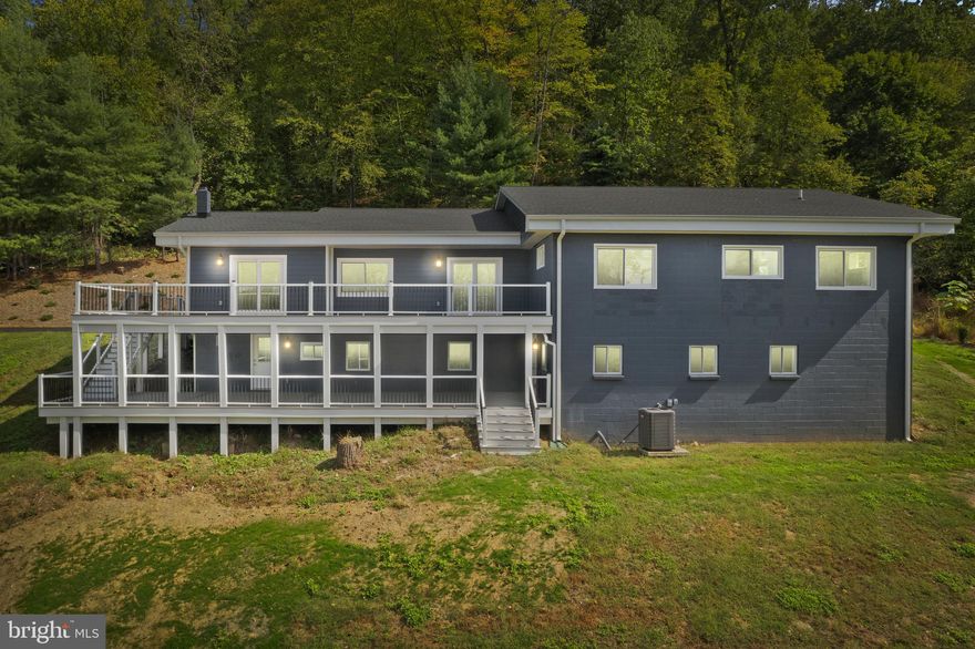 This home is so much more than a fix and flip.  These owners, meticulously redesigned, rebuilt, and refurbished this home from the foundation up over 3 long years.  This was a complete rehabilitation of an amazing mountain hideaway in the hills of Western Frederick County, MD.  Situated just 14 minutes from Route 40 or Interstate 70 in Frederick County, this home is more convenient than you would ever suspect and just minutes from some of the best schools in the area.  The full synthetic two level decks both offer some amazing mountain views looking west while the front of the home features a new oversized paved driveway and a hill of landscaping to lessen maintenance.  The selections inside this home are exquisite featuring engineered hickory floors, upgraded granite and cabinetry throughout the home, tiled showers, huge double walk in showers, a layout to maximize all views from the main and basement levels, recessed LED lights throughout, and so much more.  The owners even took the time to create a turnaround in the driveway needed for ease of access.  The home had its entire septic replaced in 2023, HVAC, Water Heater are 2024-2025, Roof and Gutters are 2022, windows 2023, all plumbing 2022-2024, leaving a new buyer with essentially no major ticket items untouched.  This one is essentially a new home on a 1970 foundation.  All work was permitted through the county.