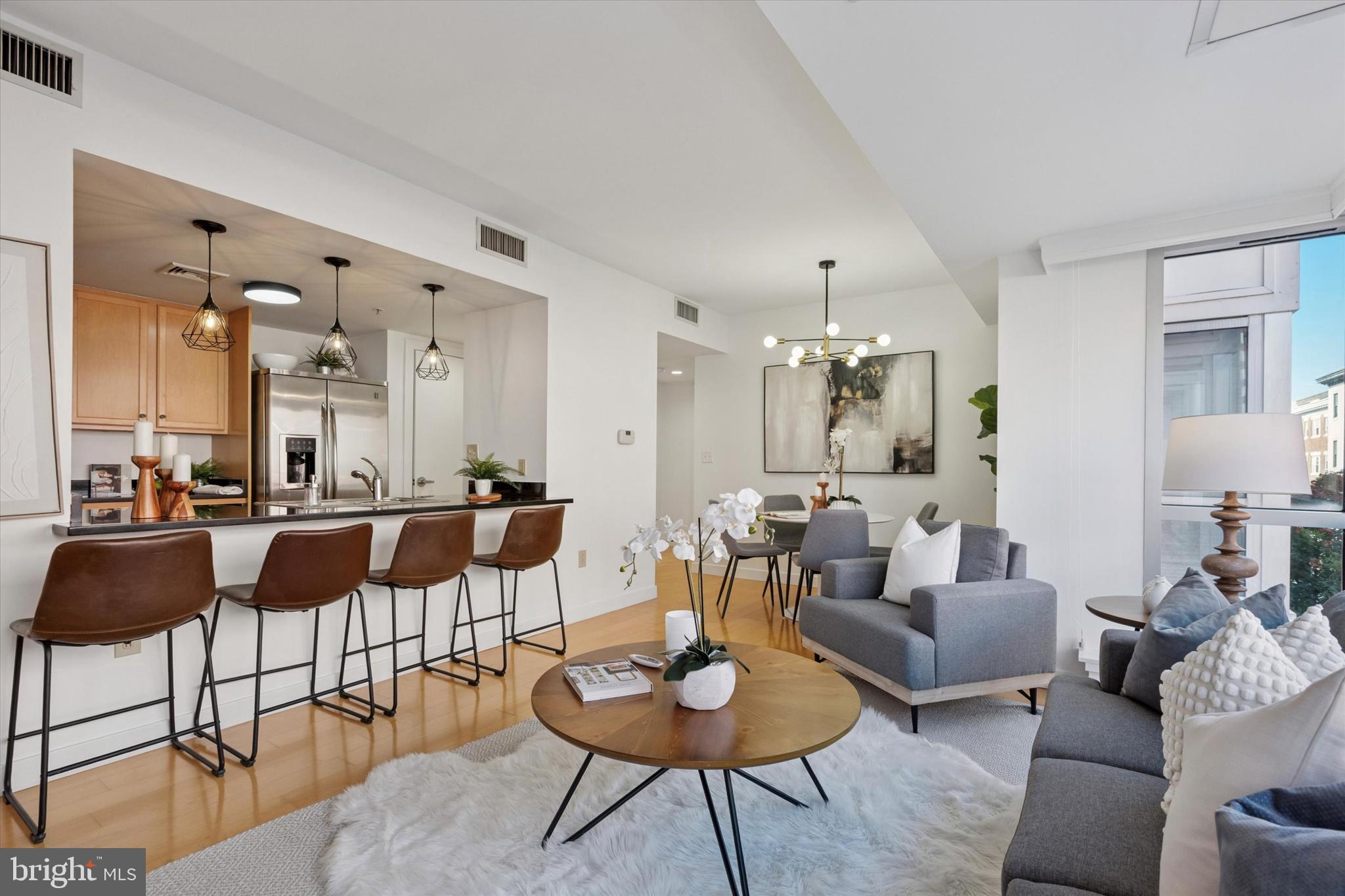 Experience city living at its finest in this spectacular 2-bedroom, 2-bath residence at Le Grenier, one of the most coveted boutique buildings in Washington Square West. This spacious, beautifully updated condo showcases high-end finishes throughout—including sleek stainless steel appliances, granite countertops, rich maple hardwood flooring, abundant storage, a newer washer/dryer, and tastefully upgraded tile baths. The primary suite offers floor-to-ceiling windows with skyline views, blackout window shades, a walk-in closet, and a spa-like bath with an oversized shower. The second bedroom features a generous closet and access to a hall bath with a deep Roman soaking tub—perfect for relaxation. The split floor plan with a bedroom suite on each side of the kitchen/dining room area lends itself perfectly to a home office, roommate, or guest bedroom setup. Set within a secure, quiet building with a stylish lobby and just three units per floor, privacy is a hallmark here. Each residence is separated by stairwells or elevator shafts, minimizing shared walls. Amenities include ample basement bike storage and several convenient parking options nearby. Situated in one of Philadelphia’s hottest neighborhoods, you’ll be steps from acclaimed restaurants, shops, and nightlife, and within walking distance to Jefferson and Pennsylvania Hospitals. With easy access to major highways, this condo offers both convenience and sophistication. Don’t miss this prime Le Grenier residence with exceptional privacy and breathtaking city skyline views!