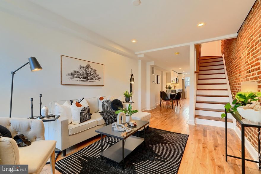 Welcome to 1351 Andre Street.  This completely renovated 4 bedrooms above grade Locust Point with a  10-year CHAP TAX CREDIT(pending approval) is an absolute stunner! Spanning 4 levels and culminating with spectacular views of South Baltimore and the Patapsco river. Walking into the home you are greeted with a flood of natural light, gleaming hardwood floors, and a completely repointed brick wall. The custom kitchen is perfect for entertaining and boast quartz countertops, custom fixtures, and two tone made to order cabinetry. Enjoy the upgraded stainless-steel appliances including a free-standing range. Utilize the *Square footage in tax record does not reflect actual square footage* Home is now 1600 square feet. large elevated rear deck off of the kitchen. The fully finished basement works well as an office or a 5th bedroom complete with a full bath. Making your way to the 2nd level you will find a primary bedroom with an en suite bathroom with gorgeous fixtures and custom tilework.  The second bath on this level is in the hallway and is also adorned with gorgeous tilework and designer fixtures and services bedroom #2. As you arrive on the 3rd level you will find bedrooms 3 and 4, and the final custom 4th bathroom.  You will also love the convenient wet bar with a beverage fridge, smart faucet, and reclaimed wood beam shelves. Across from the wet bar is the door to the stairs leading you to the rooftop deck complete with composite decking and equipped with an electrical outlet.