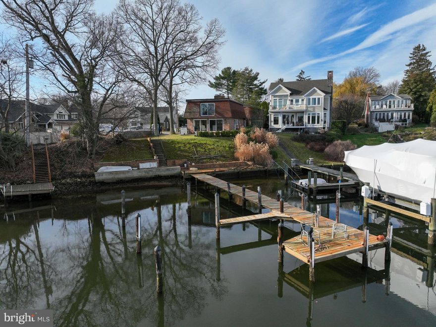 Nestled within the esteemed enclave of Whitehall Beach, this impeccably maintained waterfront residence awaits, positioned at the end of a cul-de-sac, promising a canvas for your personal touch. The awe-inspiring views that unfold from the kitchen and family room are great for a cozy gathering with a welcoming wood-burning fireplace. The seamless layout unveils a harmonious blend of spaces—a dining area, family room, and kitchen—all with captivating views of Whitehall Creek. A delightful sunroom beckons with its own fireplace, a beautifully coffered ceiling, and an abundance of windows that invite the outside in. Ascend to the upper level to discover the primary bedroom, a sanctuary boasting sweeping panoramas of Whitehall Creek. Here, a wood-burning fireplace graces the space, accompanied by an ensuite bathroom. Additional generously sized bedrooms within the main house share a well-appointed hall bathroom. Adding to the allure, a separate au pair/in-law apartment nestled at the rear of the house offers its own kitchen, living area, bedroom, and full bathroom. A detached 2-car garage provides ample storage for both vehicles and watercraft, catering perfectly to the avid boater's desires. Step onto the porch extending from the family room—a vantage point that offers boundless views stretching as far as the eye can see, perched gracefully upon a gentle slope leading to the private pier and sun deck. An entertainer's paradise, this home harmonizes luxury living with the ultimate boater's haven, boasting over 8 feet of mean low water. Embrace the opportunity to claim this remarkable property as your own—a haven for entertainment and a sanctuary for water enthusiasts alike. This residence is offered as is, inviting you to envision and realize its full potential.