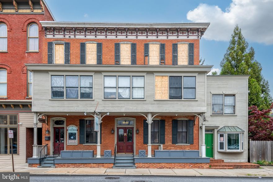 Amazing investment opportunity in the heart of Manheim!  Ability to rent out 28 to 30 units with 10-11% Cap Rate (including fix up cost & debt service).....Formally known as the Summy House, this historic property is comprised of two separate buildings on one parcel. The front building along Rt. 72 features 1 apartment in the basement, 3 commercial spaces on the 1st floor (formally the Sink Restaurant & Bar) and 2 office/studio spaces,  the 2nd and 3rd floor was used as a residential boarding house with 19 bedrooms, 3 bathrooms, and 2 kitchens.  In addition, a separate apartment built on rear of main building and an additional fully occupied 5-unit apartment building that sits along Wolf St.  This is  1 of 2 boarding houses that owners have in Manheim.  (See pro-forma of Washington House currently filled)  These buildings have been cash cows for them with waiting lists to fill any vacancies.  Main building is currently condemned from a fire and needs repaired before renting again to all units.   Structural fire damage is contained to 2-3 bedrooms and some smoke damage throughout other parts of 1st and 2nd floor.  The 1st floor and 3rd floor was virtually unaffected except for smoke smell.  Rear parking lot has 15 parking spaces, with 2 additional spaces in front of the 5-unit building, for a total of 17 spaces.  See supporting docs for repair costs, financial analysis, building layouts.....this will not last long, schedule your showing today!