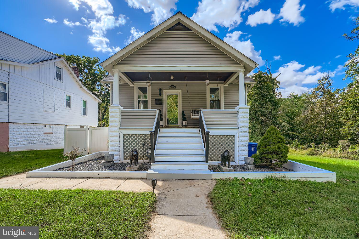 Tucked away on a desirable corner lot in the heart of Gwynn Oak, you'll find this lovely property at 5627 Wayne Ave. Enjoy serene views of greenery and the convenience of being just moments from the main thoroughfare, offering easy access to restaurants, shops, and the highway.
As you approach, the front porch offers a welcoming entry with ample space for chairs, perfect for enjoying your morning coffee or evening breeze. The main level of this home boasts a thoughtful layout featuring two comfortable bedrooms and one full bathroom with tile flooring. The living room/dining room combination is highlighted by beautiful hardwood floors, elegant crown molding, and flows seamlessly into the updated kitchen. The kitchen is equipped with stainless steel appliances, tile flooring, and attractive decorative laminate countertops and backsplash. From the kitchen, step into the spacious enclosed sunroom—a perfect spot for relaxing or entertaining! Also located on the main level is a convenient pull-down staircase providing access to the attic, which offers fantastic potential to be converted into a fully finished space, and where new insulation was installed in 2025.
Enjoy peace of mind with recent upgrades, including new house siding (2021), a new roof installed on the main house (2021) and a new roof on the sunroom (2019). The home's comfort is secured with a new air conditioning unit also replaced in 2021.
The partially finished basement, accessed from the kitchen, adds versatility to the property. This space includes two finished bonus rooms and a full bathroom. One of the bonus rooms provides access directly to the fenced yard! The rest of the basement is an unfinished space ideal for storage and laundry.  The rear yard has 2 sheds that can accommodate your gardening tools and other supplies and a wire fence.
With on-street parking and a secluded location, this home offers a wonderful blend of character, convenience, and opportunity. Don't miss the chance to make this Gwynn Oak gem your own!