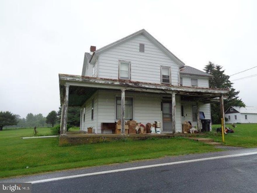 Beautiful country setting comes with this 2-story home in need of TLC and restoration. A few small outbuildings. Wrap-around porch, asphalt shingle roof approx. 10 years old, full attic, concrete floor in basement, well to east of home approx. 110' deep, 100 Amp electrical system. Septic contains a 1000 gallon tank but drain field/absorption area is questionable (see associated documents).