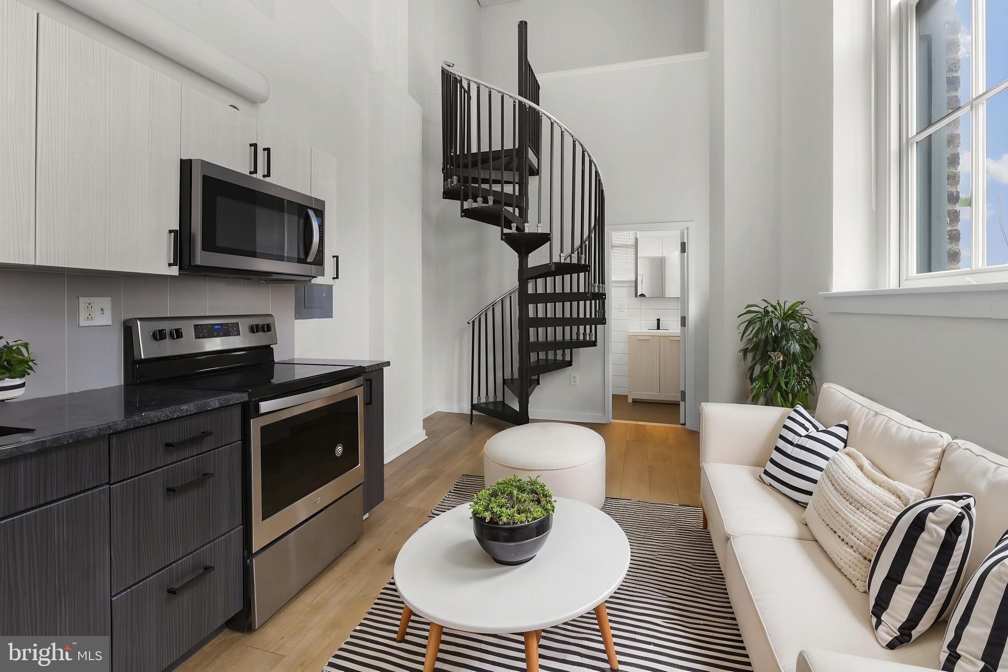 Available Early August:
Unit #PH01 is a gorgeous Lofted Studio apartment featuring high ceilings, abundant sunlight, and beautiful modern finishes throughout. Hardwood floors stretch the length of the unit and mini-split a/c systems are installed for year-round comfort. Your kitchen boasts subway tile backsplash, trendy cabinetry, a built-in microwave, refrigerator, and electric stovetop-oven. Your bathroom offers slate tile flooring, white subway tiling along the walls and around the bathtub, and a lovely vanity with convenience storage. Head up the spiral metal staircase to view your bedroom area with hardwood flooring and natural light.
A studious, upscale approach to city life, the Schoolhouse Lofts is a community of modern-industrial artist spaces inside the historic Daniel Boone School. With loft layouts and chic urban character, you'll feel the energy of the City of Brotherly Love, while pleasantly finding yourself in the heart of Northern Liberties. Beautifully renovated, it now brings a unique mix of old and new with trendy design elements, such as minimalistic lighting fixtures, exposed beams, original brickwork, and fantastically intricate details, all the while retaining its original soul. Enjoy an Amazon Package Hub for added convenience. There are FREE laundry rooms in the building, 1 on both the 1st & 2nd floors and 2 on the Penthouse Floor.
Lease Terms:
Generally, 1st month, 12th month, and 1 month security deposit due at, or prior to, lease signing. Other terms may be required by Landlord. $55 application fee per applicant. Pets are conditional on owner's approval and may require an additional fee, if accepted. (Generally, $500/dog and $250/cat). Tenants responsible for: electricity, gas, cable/internet, and water. Water & gas are billed by a 3rd party company, Conservice. Landlord Requirements: Applicants to make 3x the monthly rent in verifiable net income, credit history to be considered (i.e. no active collections), no evictions within the past 4 years, and must have a verifiable rental history with on-time rental payments. Exceptions to this criteria may exist under the law and will be considered. Cosigners accepted.