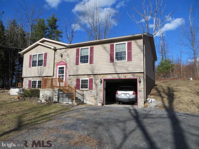Enjoy country living on a 1.2 acre lot with above ground pool and fantastic deck for entertaining & watching wildlife. Light & bright living room and open kitchen/dining area with plenty of cabinets & pantry. Master bedroom bath has walk-in shower. Lower level has space to finish another room, laundry area, plenty of storage & is pre-plumbed for additional bathroom. Enjoy this home all summer with central air & all winter with the efficient heat pump.