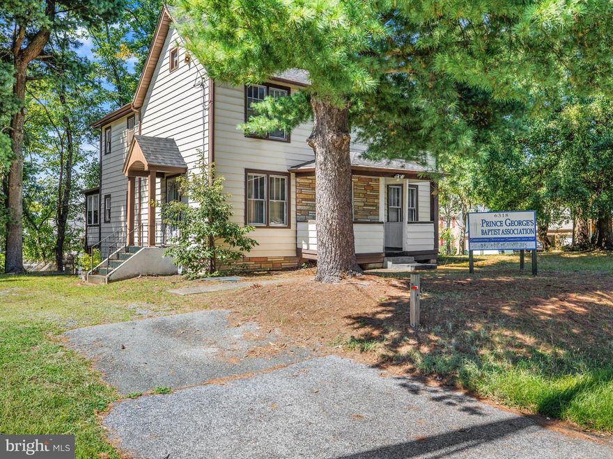 The zoning allows for a number of various uses.  Previously, the property was used for the Prince Georges Baptist Association with an Exemption status (school/church),   Although it's an older structure, it's unique in that it has a front porch facing Princess Garden Parkway and has an extended  backyard facing and adjoining Pricilla Court, which is land and can be purchased separately.  It's large enough to erect a new structure or extend the present house.   Once entering the driveway there are  parking spaces  beginning at the front door and continues to the end of the property.  There are approximately 15 parking spaces and a 2-car garage. The rooms are large and the kitchen can be made functional by the new buyer.  There is another enclosed porch which can be exited or entered from any part of the yard.  Look up the number of homes and businesses located on this street.  The basement is small and unfinished.