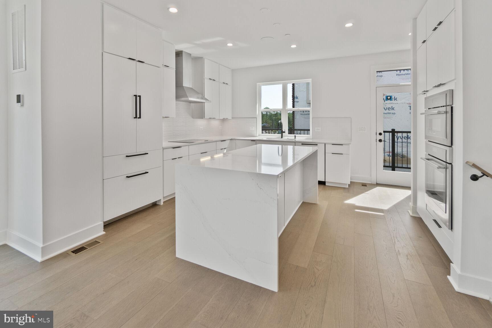 Indulge in luxurious urban living in the heart of Bethesda with this sophisticated NEW CONSTRUCTION end-unit Brownstone with Elevator. Crafted with meticulous attention to detail, this residence boasts rich architectural details and an elegant brick facade, set amidst lush green spaces and upscale new retail establishments.
Step inside to discover an expansive open floor plan featuring a state-of-the-art contemporary kitchen, perfect for entertaining. The home includes a private two-car garage and a loft level with a stunning rooftop terrace ideal for relaxation. Enjoy the convenience of a private elevator for access to all four levels and embrace sustainability with an eco-friendly all-electric design. An entry-level suite provides an excellent option for multi-generational living, ensuring comfort and privacy for all residents.
Key features include four opulent bedrooms, each with carefully curated closets, four and a half luxurious bathrooms, a loft level with a rooftop terrace, and a private elevator. The two-car garage offers secure parking, and the energy-efficient all-electric design is complemented by a PWC 10-year structural warranty.
Welcome to Westbard Square, an exclusive new community in Chevy Chase, featuring 101 elegant townhomes surrounded by high-end retail, a new post office, a central plaza, and beautifully landscaped open green spaces with a children's play area.
Within 100 feet, you'll find a selection of fine establishments and services, including:
- District Dabble Lab
- Giant
- Kumon Math & Reading Center
- Oak Barrel & Vine
- Piccoli Piatti Pizzeria
- Starbucks
- Silver and Sons BBQ
- Stretch Zone
- Tatte Bakery & Café
- Voorthuis Opticians
- Westwood Barber Shop
- Westbard Dental
A short five-minute stroll leads you to Kenwood Station, offering additional luxuries such as:
- Whole Foods
- Hunan Kitchen
- Ledo Pizza
- Georgetown Bagelry
- Sarah’s Handmade Ice Cream
- UPS
This luxury brownstone at Westbard Square invites you to experience an unparalleled lifestyle of elegance and convenience.