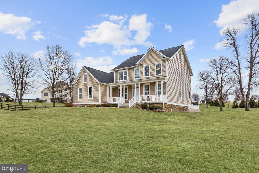 Spotless and virtually brand new, this home will not disappoint. Gourmet kitchen with modern open floorplan, opening into large family room area with two story ceilings and stone fireplace, filled with natural light from the many windows. Hardwood floors throughout first floor, tray ceiling in formal dining room, and master suite with heated floors in the bathroom. Four more bedrooms and two full bathrooms upstairs. Deck looks out over large back yard. Ample room for entertaining, both indoors and out! Don't wait, this one won't be on the market long.