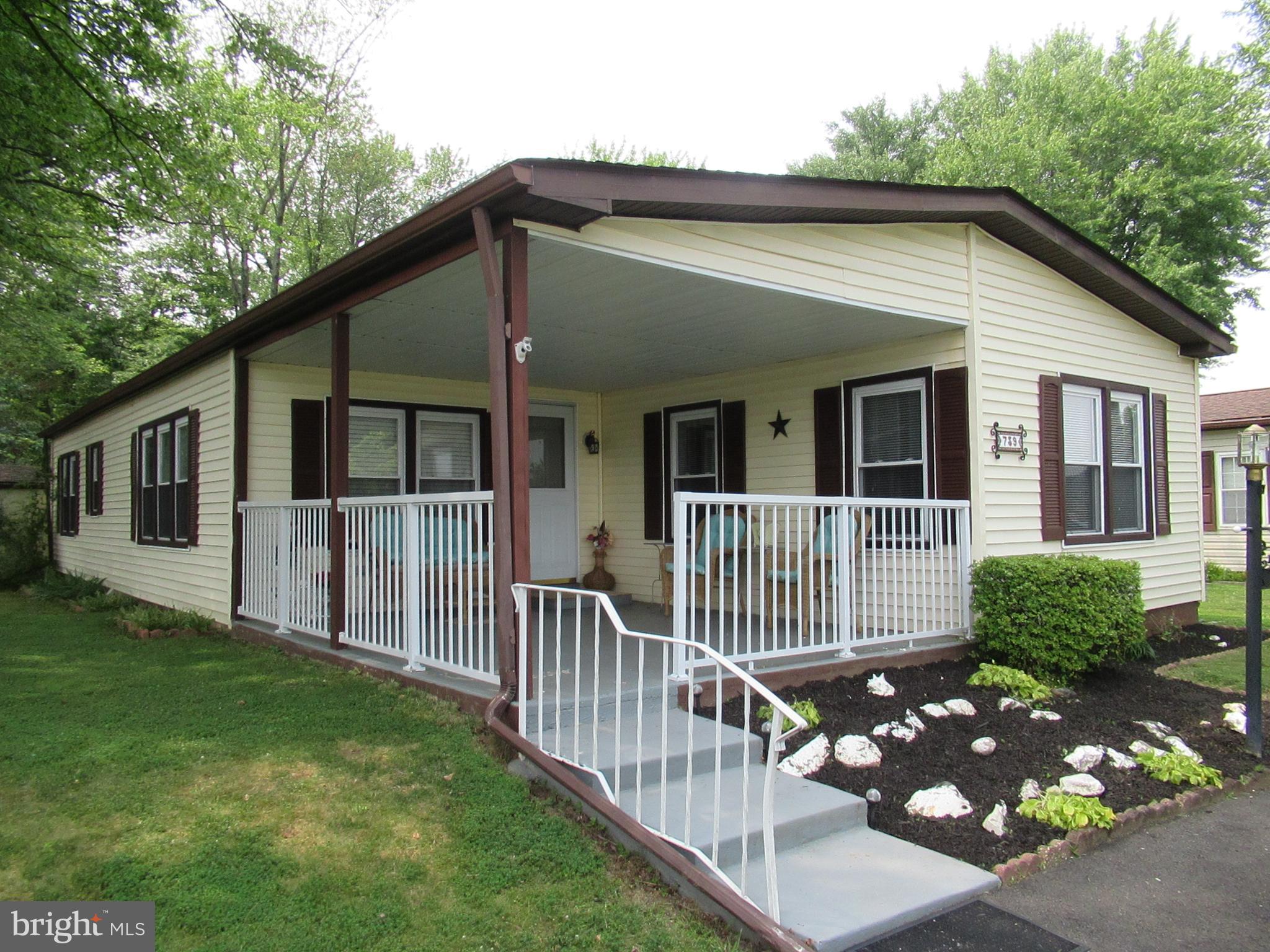 LOCATION! LOCATION! LOCATION! One of the best in the Village of Neshaminy Falls 55+ community - backs to trees - no neighbor behind you - on a "no outlet" street! The inviting covered front porch has plenty of room - great to relax and unwind. The entrance leads to a spacious living room with cathedral ceiling and lots of windows for natural light. Kitchen with breakfast bar, many cabinets and counterspace, double sink and dishwasher - with open floor plan to dining room. Dining room has a built-in hutch and sliding door to the deck - the perfect spot to enjoy your coffee while you listen to nature. Primary bedroom has its own full bath with stall shower. The 2nd bedroom is just a few steps away from the full hall bath/laundry room. There's a shed out back and 2 parking spots right in front of the home. The best tho - the BRAND NEW (built 2025) clubhouse with a community room and library. Many scheduled activities are planned daily - trips, bus service for shopping, clubs, bocce, shuffleboard, etc....and of course, the fabulous outdoor pool! Don't forget about the Montgomery Township Community and Recreation Center - its just across the street from the community - full fitness center, basketball, pickleball, scheduled fitness classes daily. Seniors and residents of Montgomery Township get reduced rates - check it out! Many restaurants, shoppes, grocery stores, hospitals, movies and an easy drive to the turnpike and major routes! This home is available for a quick settlement!