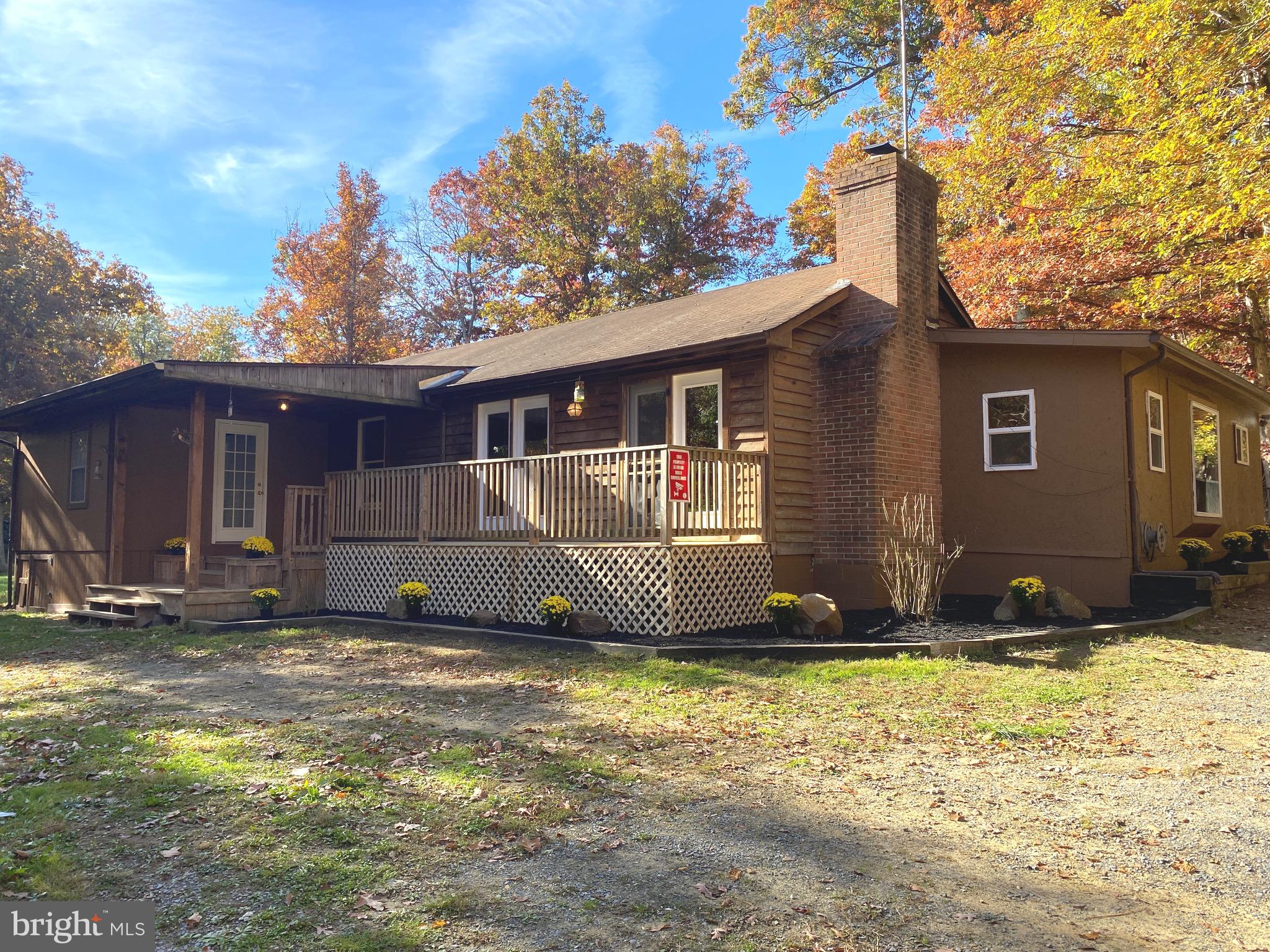 ***MULTIPLE OFFERS - SUBMIT HIGHEST AND BEST BY 5PM WED. 11/1.*** Only minutes from town you'll find yourself right at home and nestled in seclusion on this beautiful 5 acre mountaineer homestead! Whether you use this as your permanent residence, second home, or family retreat you will revel in the beauty of this gorgeous property with its wet weather stream and its magnificent level landscape. So much to say about this property! The 3BR/2BA rancher has been rehabbed with new flooring and painting throughout. Large bonus room off the kitchen. Separate dining area. Large master bedroom with its own full bath. Front deck for relaxing on a lazy afternoon and back deck for your barbecue grill, both with room for your outdoor furniture. You'll be set up for guests or income potential with the 1 bedroom/1 bathroom apartment that sits atop one of your detached 2 car garages. There are 2 entrances to this property, one for this apartment residence. Your 2nd detached garage is a grand 35'X23', with 2 bays and set up for a car lift. You'll get a lifetime of pleasure from these 5 fertile acres whether it be through tending your garden, throwing your horseshoes, sitting around your bonfire, or simply basking in this picturesque setting. Right now she's displaying every color of the spectrum! Close to the VA state line.