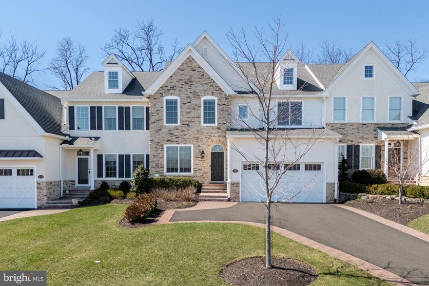 The Villas at Saucon Valley offer an exceptional lifestyle beside the scenic fields of LEHIGH UNIVERSITY, framed by expansive MOUNTAIN VIEWS. This CARRIAGE-STYLE TOWNHOME showcases LUXURY finishes and timeless exterior details including classic STONE AND STUCCO, COPPER ROOFING, and elegant BRICK WALKWAYS. Inside, a BRIGHT, OPEN LAYOUT is designed for comfort and entertaining, featuring rich HARDWOOD FLOORS and refined millwork, including CROWN MOLDING and WAINSCOTING in the foyer and dining area. The spacious great room is anchored by a dramatic FLOOR-TO-CEILING STONE FIREPLACE and a WALL OF WINDOWS that fills the space with NATURAL LIGHT. The beautifully appointed kitchen offers THERMADOR APPLIANCES, GRANITE COUNTERTOPS, and CUSTOM CABINETRY. Upstairs, the PRIMARY SUITE is a private retreat with a SPA-LIKE BATH and TWO WALK-IN CLOSETS. Two additional bedrooms each feature an EN-SUITE BATH, plus the convenience of a SECOND-FLOOR LAUNDRY. The expansive UNFINISHED BASEMENT provides excellent flexibility for HOBBIES, RECREATION, or STORAGE. Outside, the PRIVATE BACKYARD with a FLAGSTONE PATIO, RETRACTABLE AWNING, and FIRE FEATURE is perfect for morning coffee or relaxed evenings. Ideally located just a 3-MINUTE DRIVE to SAUCON VALLEY CC and MINUTES to HELLERTOWN’S MAIN STREET and DOWNTOWN BETHLEHEM.