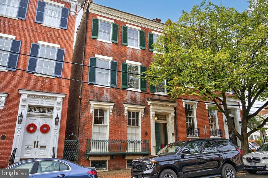 This exceptional 1850  Federal row house is on the market for the first time in decades.  Built by James F. Carlin, a wealthy Alexandria merchant, and owned by the Carlin decendents for most of its 175 years, this  property offers a fabulous SE Quadrant location and a wonderful piece of Alexandria history. The wonderful floor plan's main level includes a double parlor with 12' ceilings and stunning fireplaces, a spacious dining room with a fireplace and attached butler's pantry with service door to the kitchen.  The light filled,  spacious kitchen  opens to the rear and side patios. A half bath is also located on this level.   The upper level offer a spacious suite with a primary bedroom and a library accessed through pocket doors as well as a dressing room and an adjacent bath.  Both the primary bedroom and ensuite sitting room have fireplaces.  A large family room with fireplace, an additional bedroom with fireplace, a washer/dryer area and a full bath complete the second level.  The top floor offers two additional bedrooms with fireplaces, a dressing area or office and a full bath.   Other than the kitchen, floors throughout the home are heart pine.  The living room, dining room, foyers and staircases have just been refinished and are absolutely gorgeous.  There are 9 fireplaces in the home.    The lower level has a large unfinished basement with a staircase to the enclosed patio. The exterior walled patio leads to the front entry to the property as well as to the rear alley.  The property includes a separate brick structure which would be a lovely gardening room or outside kitchen. 

Remodeled in 1992, and believed to be in very good condition.  One of the ac compressors was replaced this summer. This property is  in an estate and is being offered 'as is'.