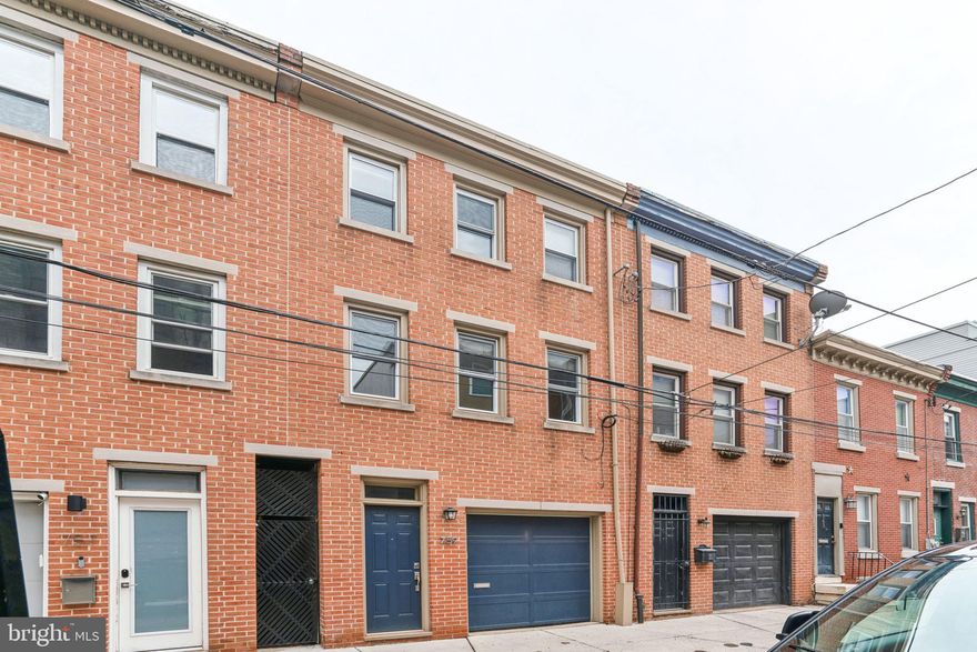 Enjoy your own private GARAGE with interior access to your single family townhome on a great block with a HUGE fenced back yard + a large deck off the kitchen! 759 S Mole St is situated on a quiet street near 16th & Fitzwater in the heart of Graduate Hospital - convenient to Avenue of the Arts/Broad St, Rittenhouse, Jefferson and Penn. Enter through the front door or the garage - which also has room for storage - to the first level of this 3-story home. Spacious coat closet. Handy tiled powder room + laundry room with storage. Walk out to the fenced brick backyard with beautiful planting. A place to throw the baseball, grill, relax or entertain. Back inside, straight stairs to the second floor. A built-in bookshelf at the landing. Upstairs, an extra large living room with 3 windows bringing in tremendous light. A fireplace warms the room. Hardwood flooring. Also on this floor, a gourmet kitchen with lots of storage and counter space + a study/homework spot. Glass sliders to a large deck that brings the outdoors in. Up the stairs to the top floor, where you'll find two spacious bedrooms with vaulted ceilings + an exposed brick wall and upper level loft style storage. Plenty of closets and windows. Updated and elegant tile bathroom with shower/tub on this floor. Schedule your showing today!