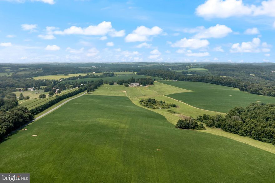 Rarely is such a large farm available in Chester County!  This 173+/- acres farm is set in a region known for its strong preservation efforts with over 30,000+ contiguous acres under permanent protection. The farm has enjoyed many purposes over the years including a country retreat, horse-training facility along with producing bountiful crops from its many rich, fertile fields.  Regardless of the purpose, the views and quality of life are magnificent over the gently rolling hills in the Chester County countryside.
 The original home was built in 1880 and was renovated, and expanded, in 1985. It features 5 bedrooms, 2 full baths and 2 powder rooms providing ample space for a large family or guests. Enter the home through a welcoming foyer with curved staircase and glass windows. The spacious and comfortable living room is designed with built-in bookcases, perfect for displaying art pieces, and features wood flooring, marble fireplace, dental work details, floor-to-ceiling windows and pocket doors. To complete the entertaining area there is a 4-season room overlooking the pool outside with an open ceiling of exposed beams and peg construction, and glass sliders to the pool outside. This area also includes a convenient bar area and a powder room. The kitchen is equipped with double ovens, stainless steel counters and its own fireplace. There are numerous closets and pantry spaces for storage convenience and a separate entrance with a charming office/mudroom with quaint fireplace.  A greenhouse alcove with a slate floor is an attractive feature for plant enthusiasts and links the dining area to the kitchen. The lower level has a brick floor and a spiral staircase previously used as an entertainment and dining area. It also houses a vault or large safe for added security. Attached to the main home, is a nanny/in-law suite with 2 bedrooms, living room and kitchenette.  The home is ready for further updates and the personal touch of a new owner.
 A 3 bedroom, 2 bath carriage house is also on the property and is nicely, yet conveniently, sited. There is a country kitchen with eating area, dining room, living room and mudroom with washer/dryer and bath.
For the hobbyist or horse enthusiast there is an impressive facility of barn and equipment buildings, fenced pastures and exercise rings. The barn currently includes 16 large (14x14’), as well as large foaling stalls (20x20’) and has a wonderful loft with ventilation and storage space. Other amenities within the barn include a tack room, wash stall, and a grooming area with washer-dryer setup. An attached large turnout shed, and hay/equipment shed, provide additional convenience for horse care and other farm needs.   Designed for optimal care and maintenance of vehicles and equipment, there is a large 2 bay garage for tractors and/or vans, plus, there is a 3-bay garage (with 3 added stalls on the far side).  Convenient to the barn and these buildings, there are 7 pastures with newer split rail fencing.
Additional features of the property: Act 319 for preferential taxes; property currently produces almost $90,000 annual income; primarily tillable acres with some woodlands, property flanked by 3 country roads; the very original homestead ruins still exist on far hill; in Cheshire Hunt countryside; and conveniently located to new shopping areas, major arteries, Parkesburg Train Station and the Chester County Airport (private). THE BENEFITS OF THE CONSERVATION EASEMENT WILL BE AVAILABLE TO THE BUYER.  (Please discuss details with agents as this can be very financially beneficial to the Buyer plus the Buyer could further plan the use of the property.)