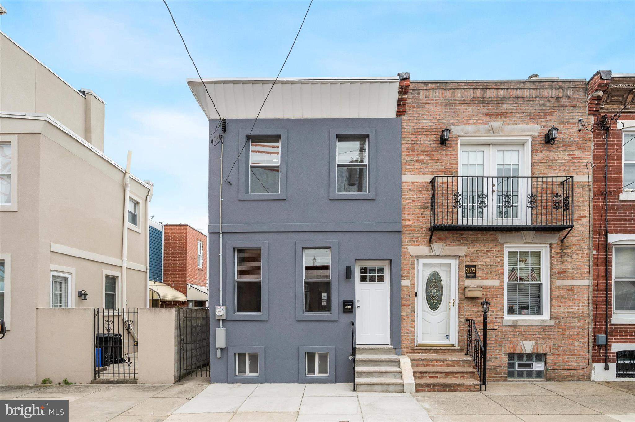Don't miss out on this newly renovated Port Richmond home. The building exudes charm from the outside with a grey exterior that stands out from the surrounding builds. Inside, a straight-through space provides easy living with luxury vinyl plank flooring, recessed lighting, and a luxe electric fireplace. Towards the back of the home, the kitchen provides a great space for any budding chef with clean, white cabinetry and stainless steel appliances. From here, step outside into the private courtyard.
Upstairs, find three bedrooms with closet space and plenty of natural light. A full bath is also on this level, featuring a tub/shower and marble-like backsplash.
Downstairs, a fully finished basement adds even more living space, as well as a half bath combined with a laundry room.
Location is key here with plenty of restaurants and shopping nearby. Grab Polish food from nearby Mom-Mom's Kitchen, or head to Nemi for Mexican cuisine. The infamous Tacconneli's pizza is only a few blocks away. There are also plenty of parks nearby, as well as public transportation.
