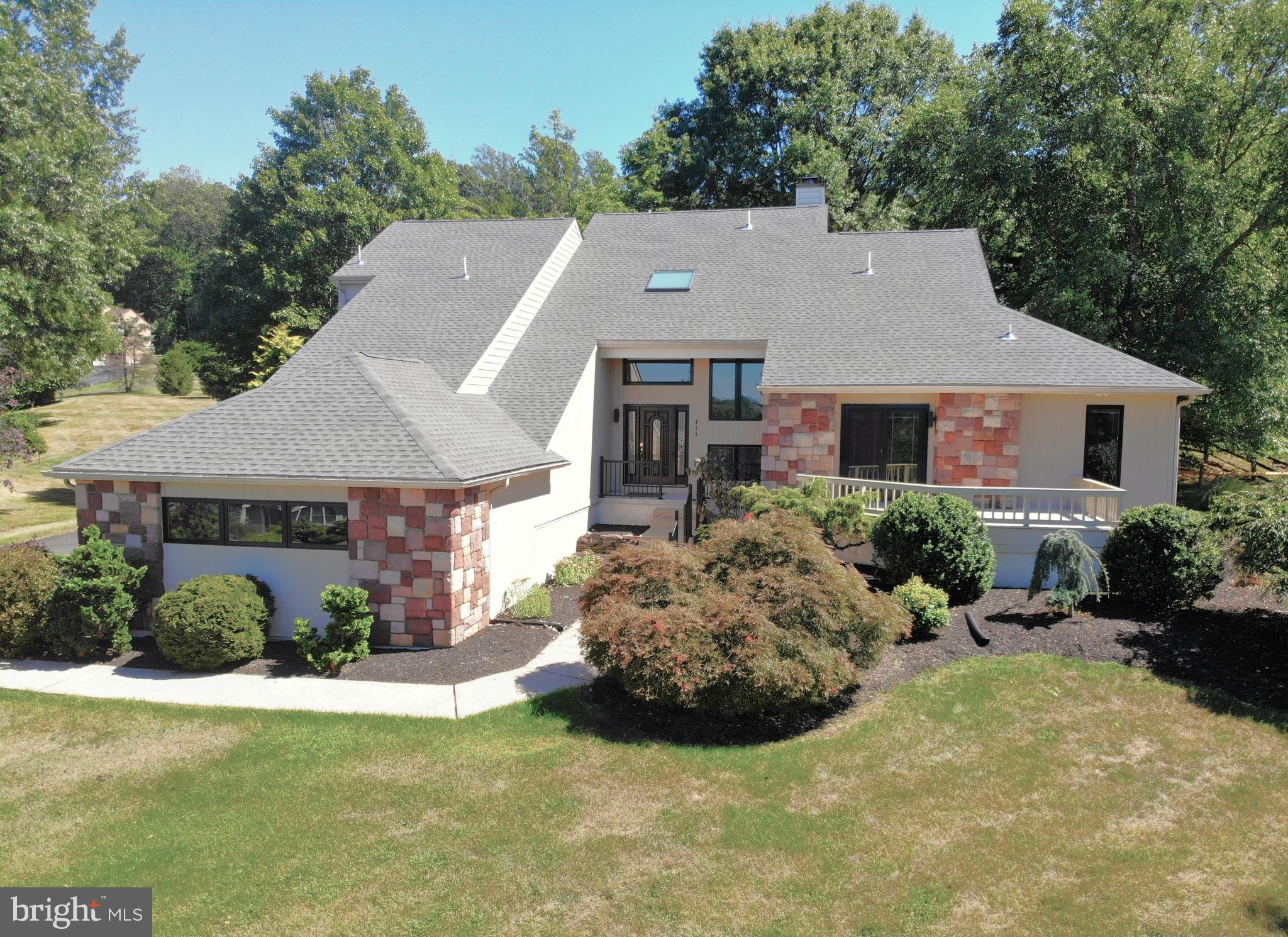 "It's a 10!!" Fantastic home & setting seen in this gorgeous 4 bedroom, 3.5 bath contemporary home offering 4,000+ sq.ft. of living space & beautiful views too. Majestically sitting atop a beautiful 1/2+ acre lot you find great curb appeal with a stone front. Inviting foyer with dramatic cathedral ceilings & skylight accenting a 18" tile floor. Large Living Room appointed with 9' ceilings, recessed lighting, a double sided fireplace with slate surround & sliders to an outside paradise. Dining room accented with cathedral ceilings & skylights. A chef's delight with an amazing gourmet Kitchen with lots of high-end custom cabinetry with under cabinetry lighting, glass block tile backsplash, granite counter tops, "top of the line" appliances with Wolf cooktop stove, double Wolf wall ovens, Subzero refrigerator, Bosch dishwasher & private bar area with a Viking beverage refrigerator, "walk-in" pantry, recessed lighting & 18" tile flooring. Fabulous Family Room with double sided fireplace & recessed lighting. Pampering 1st floor primary suite with 2 "walk-in" closets, window seat, private deck with beautiful views that provides a great place to enjoy your morning coffee or a evening glass of wine + a luxurious primary bath with double bowl vanity, huge "walk-in" tile shower with frameless glass door & tile flooring. 1st floor laundry room with laundry sink & new LVP flooring. 2nd floor offers 3 additional bedrooms all with generous bedroom sizes, 2 closets in each bedroom & ceiling fans too. Plus there is a primary bedroom with a new primary bath. A tile hall bath completes the 2nd floor. Partially finished basement provides a great place to entertain or relax & enjoy a movie. Great Outdoor living space with a new Trex Deck in 8/2025. New roof in 7/2025. Heat effectively & efficiently with an oil fired baseboard heating system. 2-Zoned air conditioning system. Over-Sized 3 car attached garage. XL driveway offers plenty of parking. Located in the award winning Upper Dublin School District. Great commuting access availability. Lots of parks nearby (Fort Washington State Park, Mondauk Common Park & more). American Home Shield Warranty is Transferable and Included! It's a great place to call "HOME"!