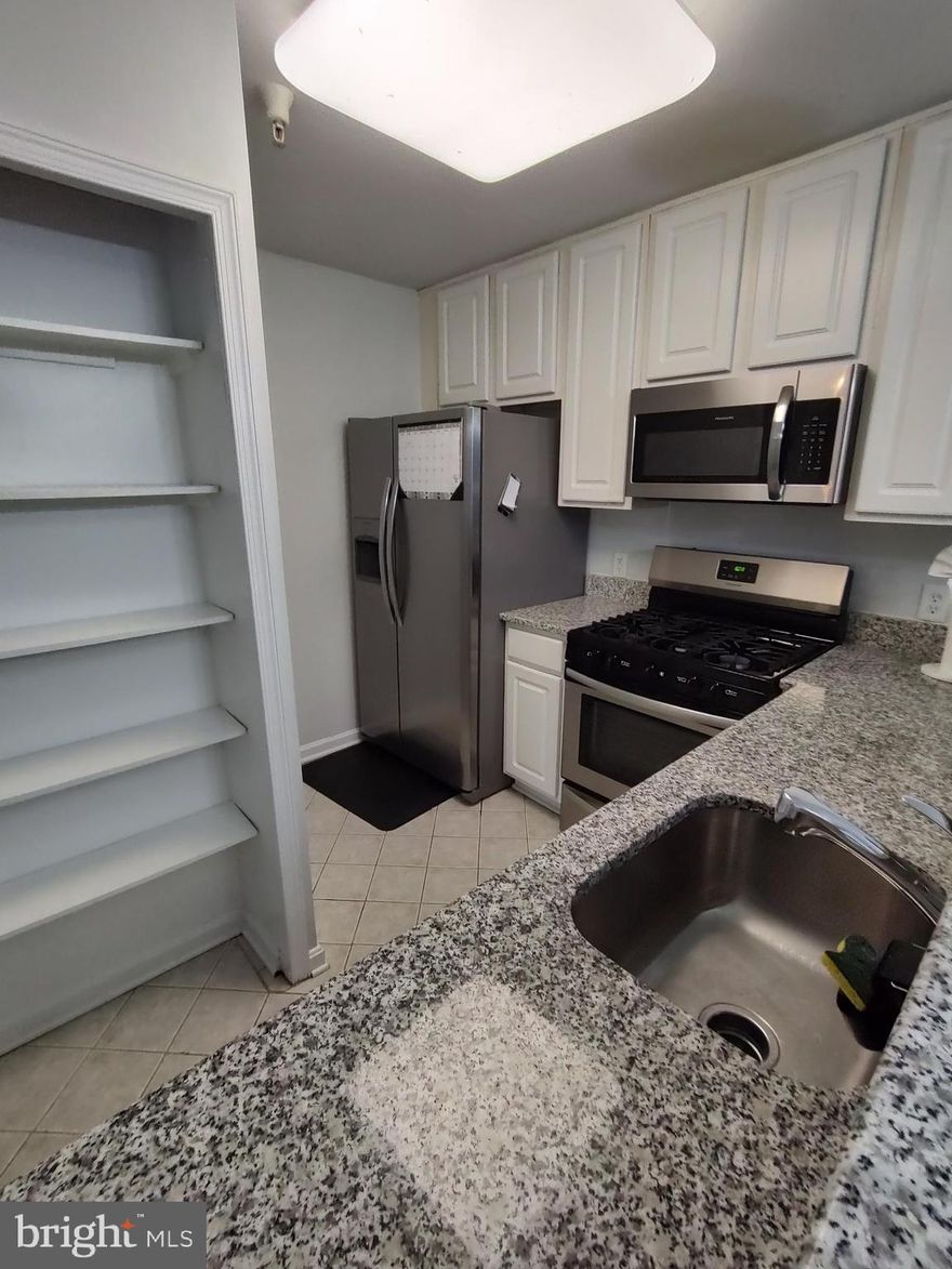 Beautiful 2bdrm, 2bthrm plus Den condo in Greenbelt.  Bedrooms are on either side of the living room offering privacy.  Laminate flooring through most of the unit - carpet in bedroom #2 only.  Primary bedroom offers a large walk-in closet and soaking tub.  Covered porch offers direct access to the exterior .  All stainless steel appliances in a remodeled kitchen with granite countertops.  Located conveniently across the street from Schrom Hills Park, along a bus route with a stop right outside the community, 5 mins to NASA, 10 minutes to either Greenbelt Metro or New Carrolton Metro, 5 minutes to Eleanor Roosevelt High School, 5 mins to BW Parkway and the Beltway.  5 minutes to shopping, grocery, banking.  VERY convenient location.  1 parking spot included with visitor parking available.  Secured building entry.