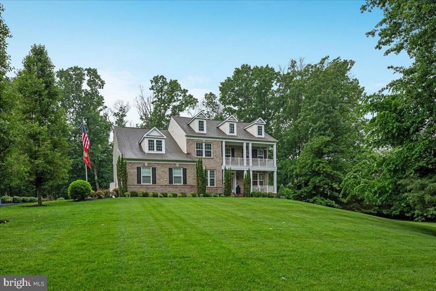 This exquisite Colonial-style home with its classic and stately presence is nestled on a beautifully landscaped, over 4 acres of wooded privacy offering a harmonious blend of luxury and comfort, perfect for those seeking a slightly rural lifestyle with a gentle touch of modern living in the exclusive and sought-after community of Huntleigh in Creighton Farms. This exceptional 5-bedroom, 4.5 bath custom estate offers over 6000 sq. ft of modern luxury living space with over $400K in premium upgrades.  This home features a symmetrical design with its front façade anchored by a covered porch with white columns that extend across part of the house, giving it a traditional and welcome look. Above, a second-story balcony that mirrors the porch below, adding both charm and architectural interest to this stunning home. The main level showcases a welcoming open grand entry with a rich and oak stained handrail and white spindles contrasting nicely against the darker wood steps. Straight ahead, a gorgeous gourmet kitchen featuring high end custom cabinetry, upgraded countertops, the heart of this home boasts a brand-new Wolf cooktop, double ovens, microwave, dishwasher, and oversized entertainment’s island along with a coffee/wine bar and lots of counter space making it ideal for your everyday living and entertainment on a grand scale. Flanked by a huge walk-in pantry and a mud room. Beautiful dark Engineered hardwood floors predominantly throughout, where you will find a warm and sun filled sunroom overlooking a private estate and mature trees. Entertain in the elegant dining room adorned with crown and chair rail molding, or gather in the formal living room for intimate moments The bright main-level office provides productive work-from home. Upper level, the primary suite has a beautiful chandelier, a stunning sitting room and a spa like bath with tub, shower complete with His/Her vanities, and an oversized walk-in closet. Two full baths with a shower and tub with Kohler fixtures. The finished lower level features a 5th bedroom with en suite with full bath, a game room, multiple areas for your own creation and two storage spaces. The walk-up basement provides a retreat featuring an extensive custom patio, fire pit and built-in grill, a 6 zones underground irrigation system and professional landscape lighting with a private alcove for relaxation and/or entertainment. The crown jewel at Creighton Farms is the 18-hole Jack Nicklaus championship golf course that you can join with additional membership. The expanded driveway leads to three car garage doors and 8 additional parking spaces. Situated on over a private 4-acre lot surrounded by nature, well-manicured walking trails, panoramic views of the gently rolling countryside, a serene creek, this one-of a-kind property feels tucked away yet remains conveniently close to the airport, railway, shopping, dining, and the Dulles Toll Road. Welcome Home!
