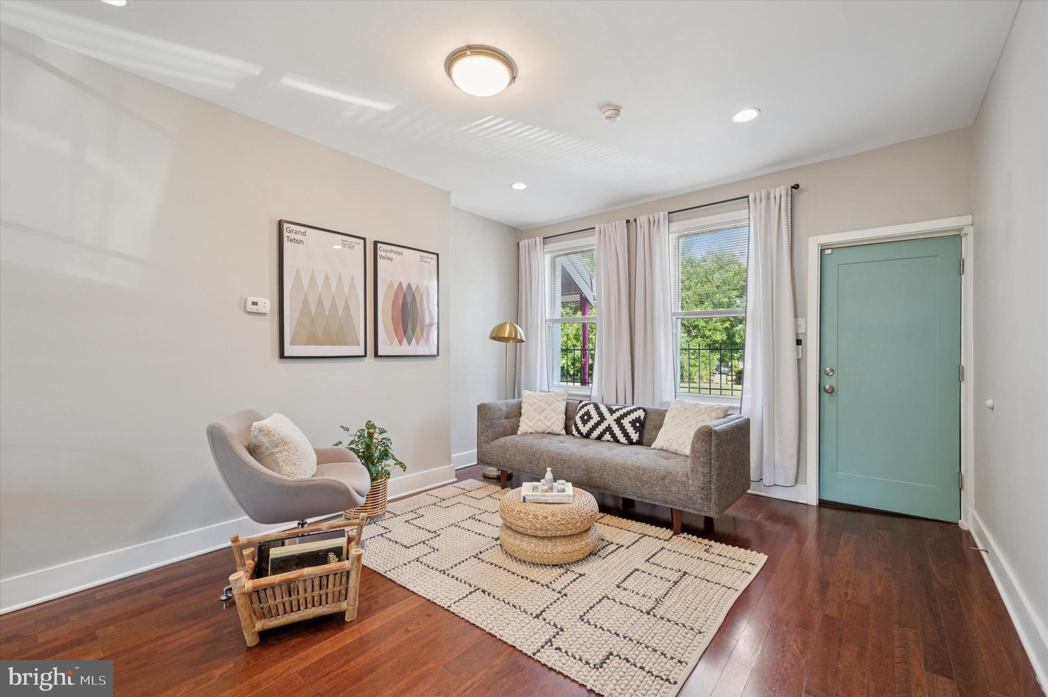 This absolutely adorable end rowhome is right off of Baltimore Ave, making it a no-brainer if you want to live in uber-walkable Cedar Park while keeping your monthly payment at (or below!) what you’re currently spending on rent. It’s got an open-plan living space with hardwood floors, high ceilings and recessed lighting. The efficiently laid out kitchen has white Shaker-style cabinets; GE stainless steel appliances; and neutral Caesarstone countertops with breakfast bar, undermount sink and pulldown faucet. There’s good light from two front windows and one overlooking the rear yard, which is paved for a low-maintenance grilling/dining/container garden situation. At the top of the stairs there’s a large hall bath, which is decked out with marble vanity, floors and not just a full-wall surround for the soaking tub, but three full walls of marble. The middle room has a good-sized closet and offers plenty of room for use as a true bedroom or as a spacious home office. Past a hall closet is the primary bedroom, which has two windows with extra-deep sills and a sweet architectural niche. And as a major upgrade from an apartment, you’ve got laundry and storage galore in the basement. Outside there’s curb appeal from the contemporary board and batten siding, one of our favorite murals in all of Philadelphia on the side wall, and an unusual amount of breathing room from neighbors with the city-owned and maintained lots next door and directly across the street. Go from hanging at home to Baltimore Ave for shopping, dining, taking a yoga class or chilling in the park with practically zero transit time from this super-convenient location, or hop on the trolley and be in Center City in 15 minutes.