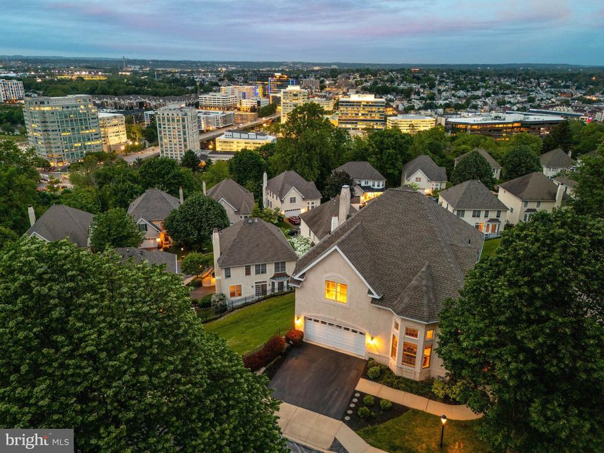 Perfectly perched, with amazing views, this exceptional three-level  residence in the coveted Merion Hill community is sure to impress! Prepare to be captivated as you step into the grand two-story entryway featuring a stunning chandelier and quarter-turn staircase. Sunlight streams into the formal living room, highlighting its soaring vaulted ceiling for an airy and inviting space. Gorgeous, refinished hardwood floors flow to the adjoining dining room, creating a seamlessly elegant place for formal gathering and intimate dinners alike. The heart of the home lies in the beautifully appointed eat-in kitchen, a culinary haven featuring rich espresso cabinetry accented by stylish open shelving and a chic tile backsplash. High-quality stainless steel appliances, including a sleek range hood, complement the expansive granite countertops, which extend into a peninsula offering both additional workspace and casual seating. A charming breakfast area, framed by delightful bay windows, provides a sun-drenched spot for everyday meals. Flowing effortlessly from the kitchen, the inviting family room serves as a comfortable retreat, complete with a cozy gas fireplace and custom wall-to-wall built-ins. Strategically positioned, this room perfectly frames the stunning vistas that stretch beyond. Oversized sliding glass doors provide direct access to the private deck, an outdoor sanctuary ideal for al fresco dining, entertaining guests, or simply savoring the spectacular scenery. A convenient, tastefully updated powder room completes the main level. Head upstairs, where the generously proportioned primary bedroom suite awaits. A double-door entry introduces this tranquil retreat, featuring a cozy gas fireplace, separate “his” and “her” walk-in closets with custom wardrobes, and a luxurious spa-like ensuite bath. Indulge in relaxation with a deep soaking tub, separate glass-enclosed shower, double vanity offering plenty of counter space, dedicated make-up vanity, and private water closet. Two additional bedrooms, each boasting ample closet space and its own ensuite full bath, offer comfort and privacy for family or guests. A dedicated laundry area on this floor adds to the home's functionality. The impressive fully finished, walk-out lower level extends the living space and offers remarkable versatility. A second spacious family room, complete with another welcoming gas fireplace, provides an additional area for recreation and relaxation. A convenient kitchenette makes entertaining on this level effortless. A separate room offers additional flexible living space, functioning perfectly as a home office, gym, media room, or guest suite to suit your individual needs. Sliding glass doors lead to a second private deck, providing yet another outdoor escape to appreciate the serene surroundings and breathtaking views. Beyond the exceptional features of the home itself, its location offers unparalleled convenience. Situated close to major roadways, commuting to the Main Line, King of Prussia, and Center City is a breeze. Enjoy easy access to a wide array of local shopping and dining options as well as the Philadelphia Country Club. Meticulously maintained and thoughtfully designed, this Merion Hill gem is an exceptional opportunity to embrace a truly remarkable lifestyle. Don't miss the chance to experience the allure of this extraordinary home – schedule your private tour today!